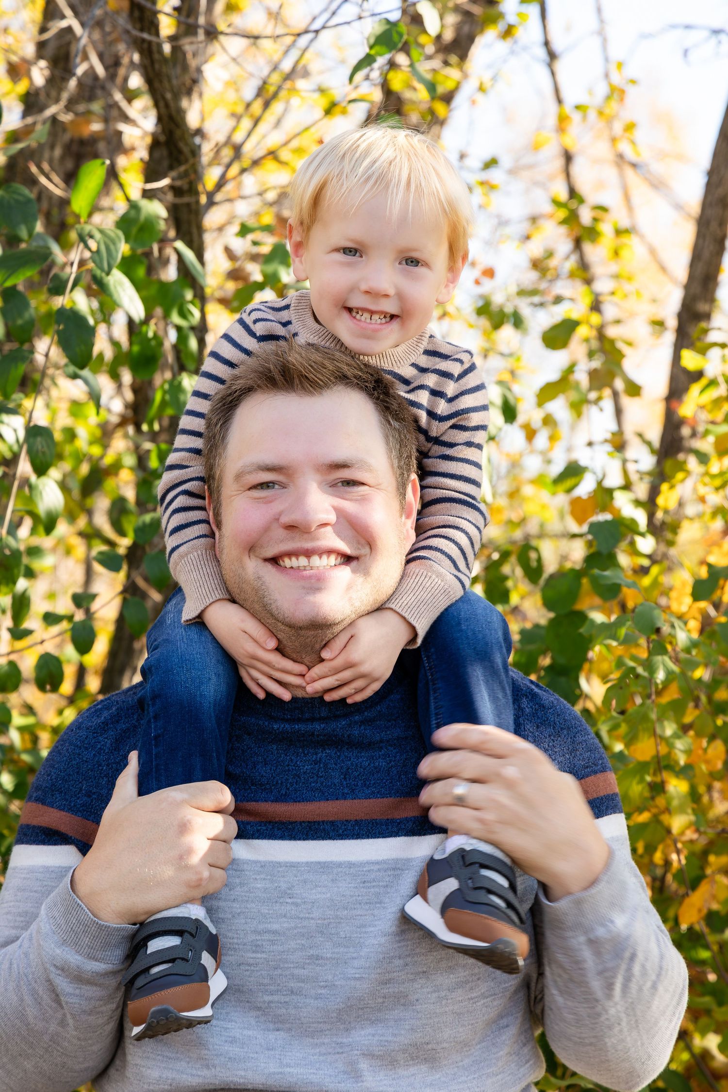 Playful close-up portrait sequence showing hands squeezing cheeks in autumn setting with fall foliage.