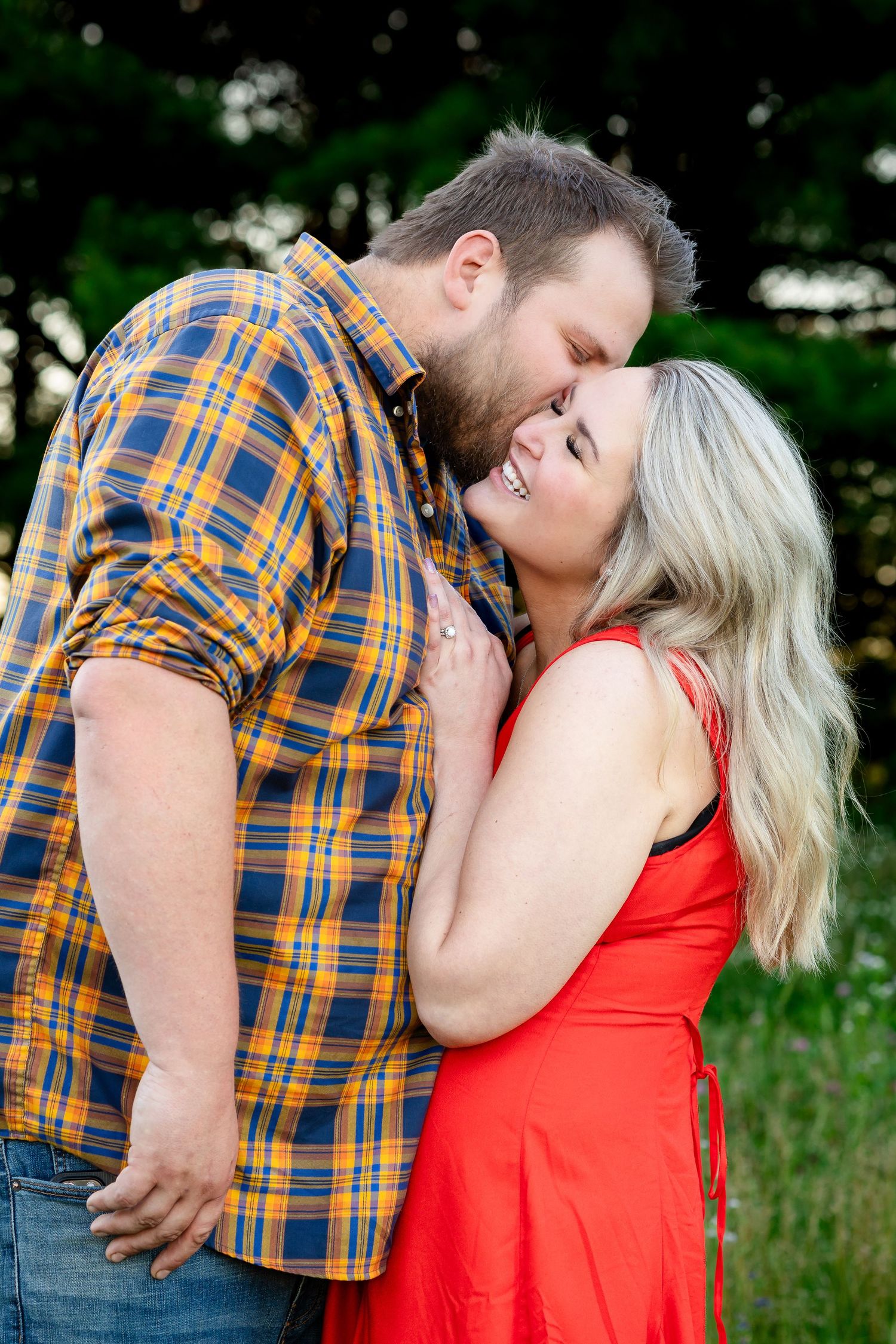 Intimate outdoor portrait showing affection and laughter.