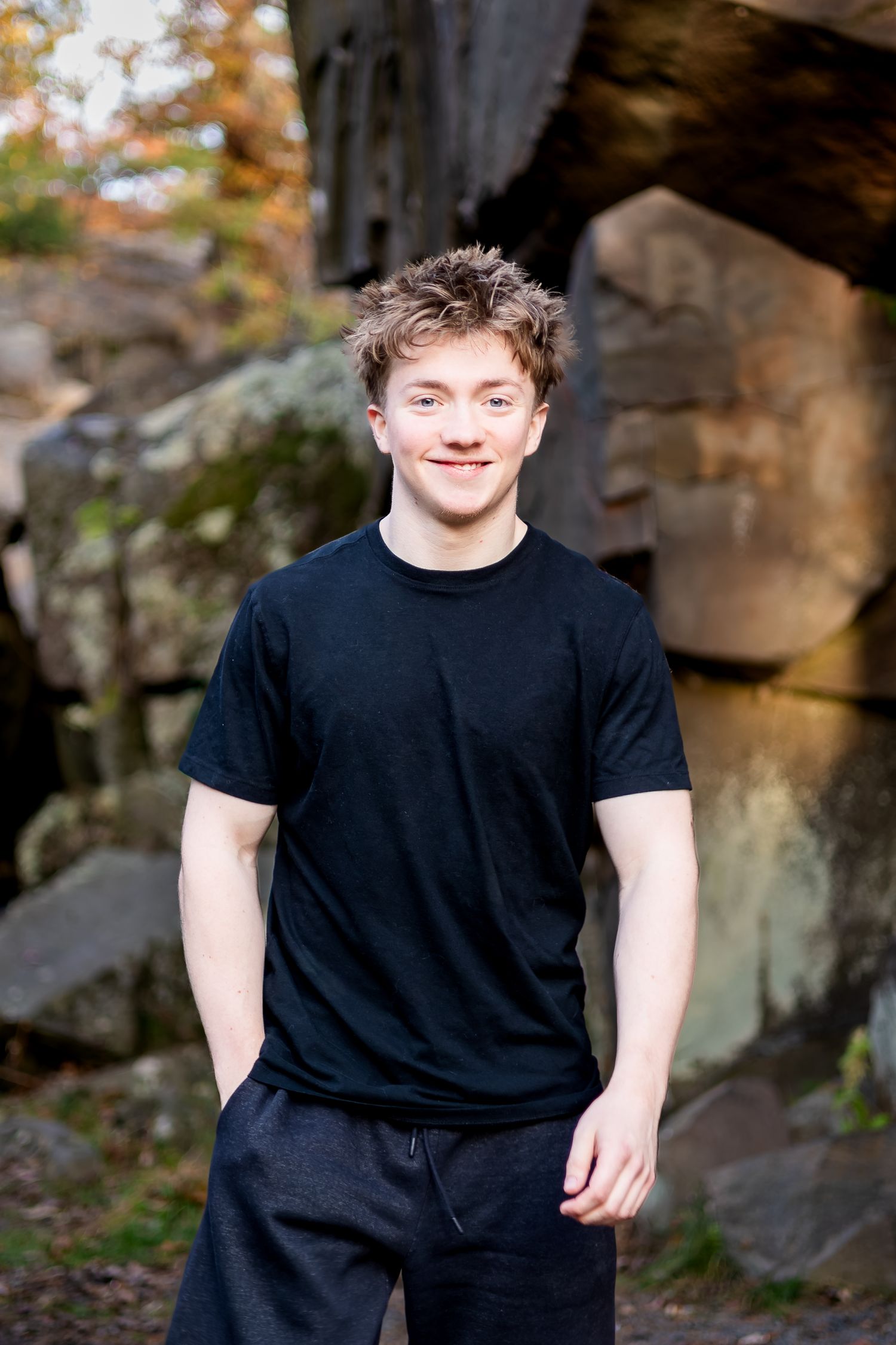 A series of outdoor portrait photos showing someone wearing a black t-shirt against a natural stone background.
