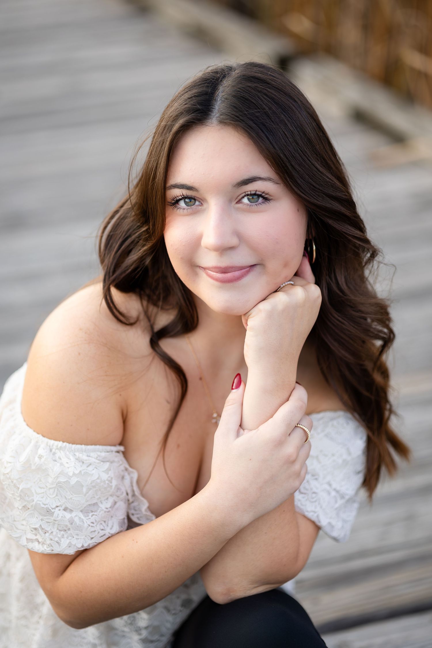 Close-up portrait series with natural expressions and white lace top.
