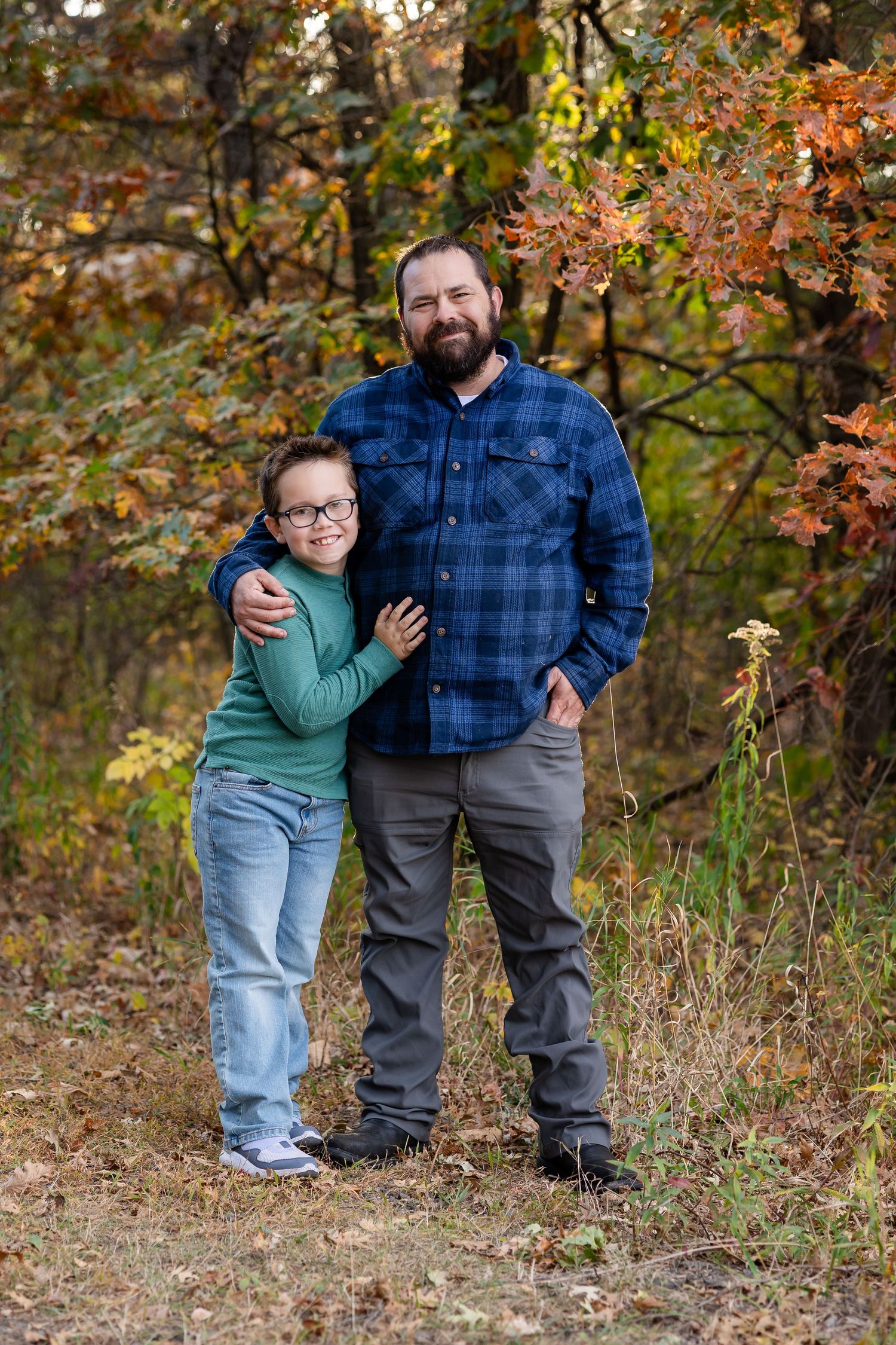 Sweet bonding moments captured between family members in autumn outdoor setting.