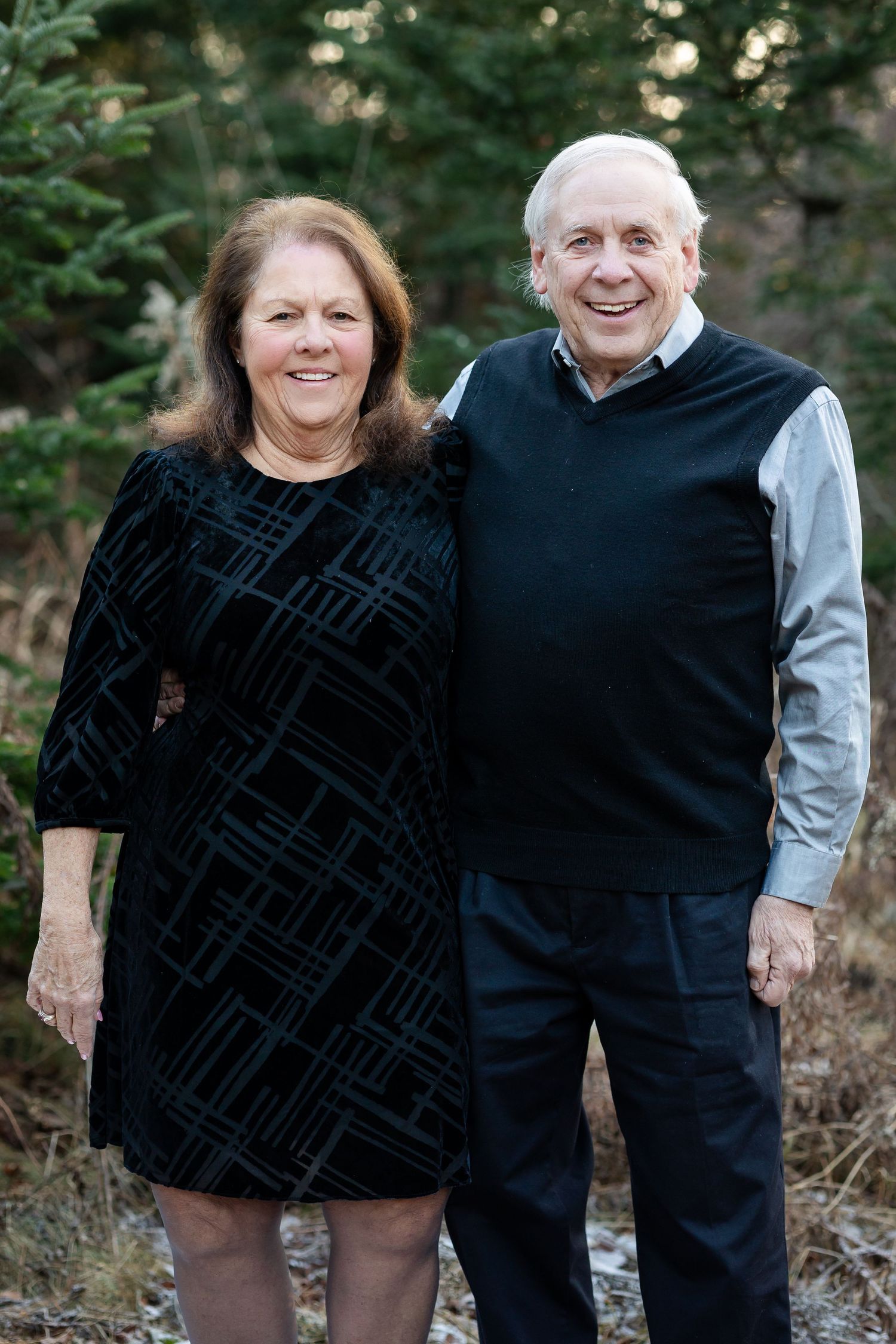 A couple in casual attire sharing affectionate moments in a series of outdoor photos against a wooded background.