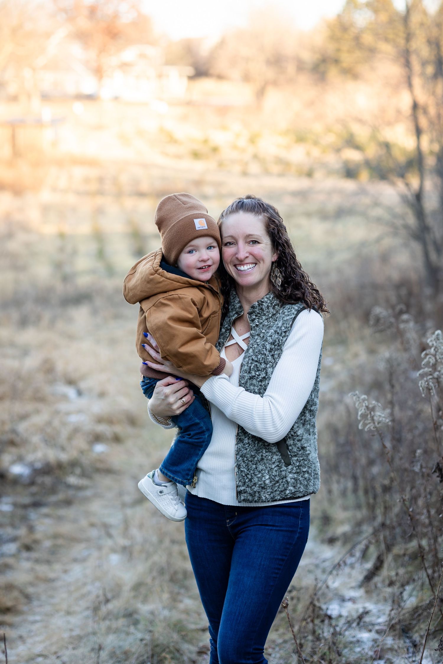 Outdoor portrait session featuring warm embraces against golden sunset backdrop.