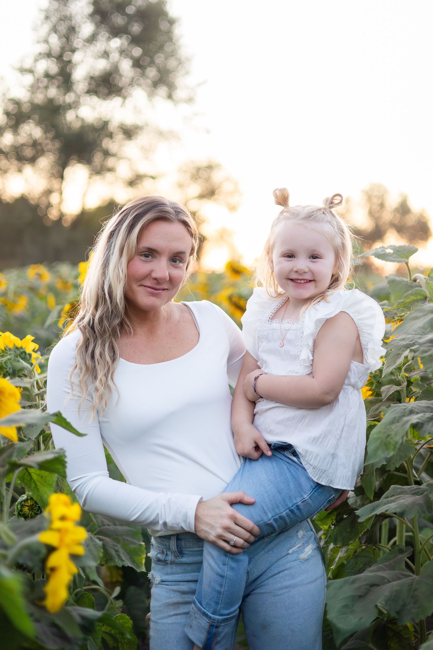 Sweet candid moments captured in sunflower field during golden hour.
