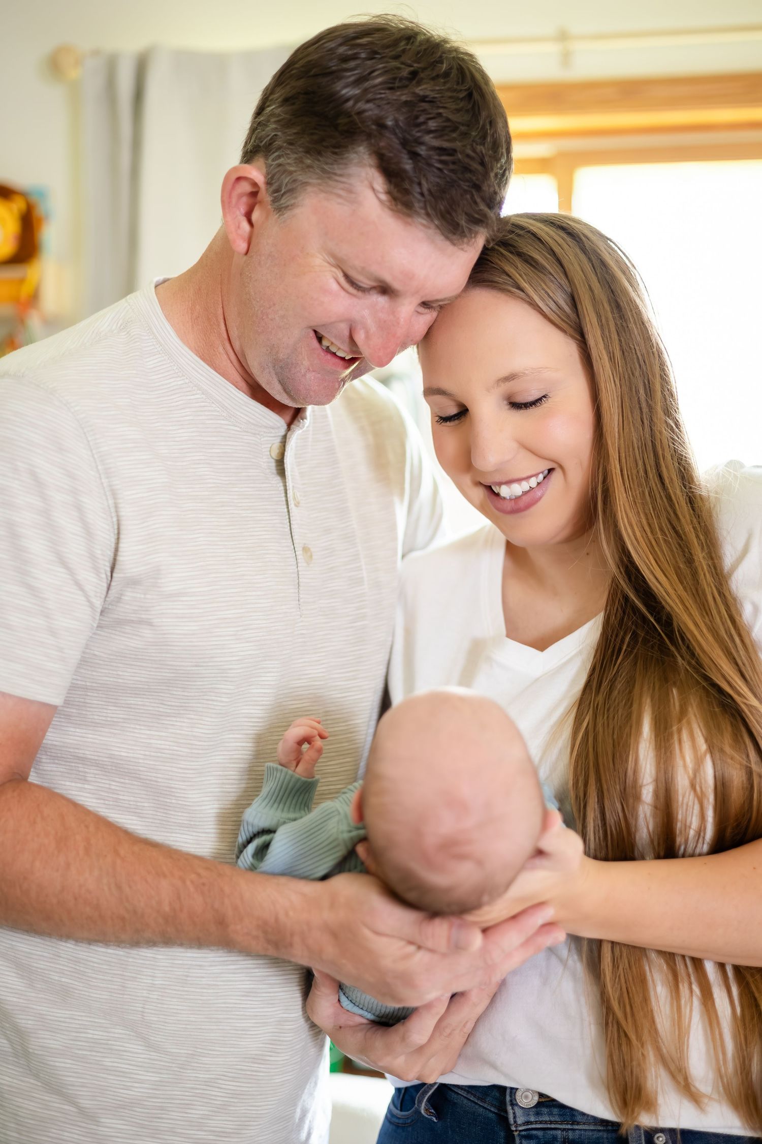 Tender family moment at home with newborn baby.