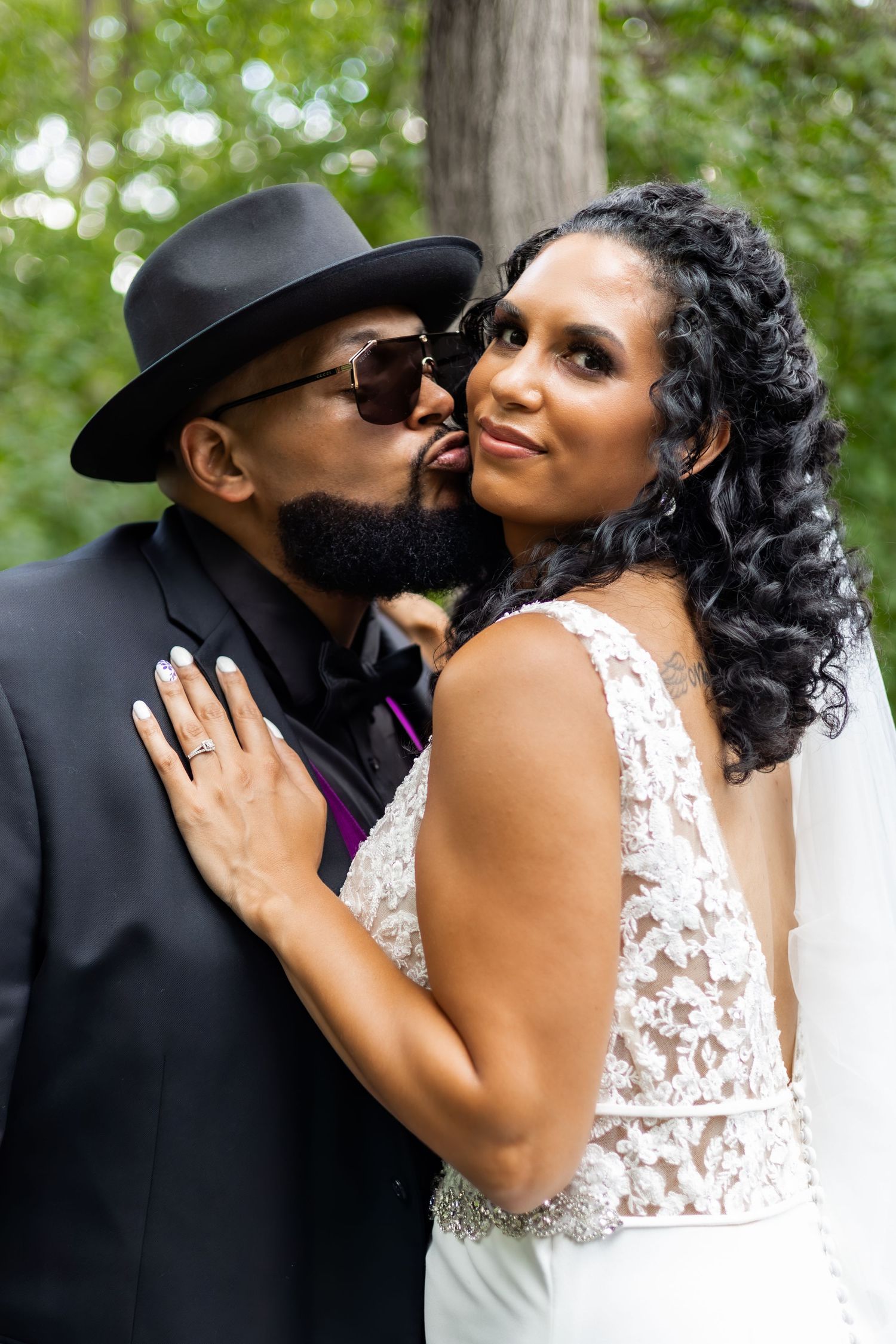 Close-up shots of newlyweds sharing tender kisses in an outdoor setting.
