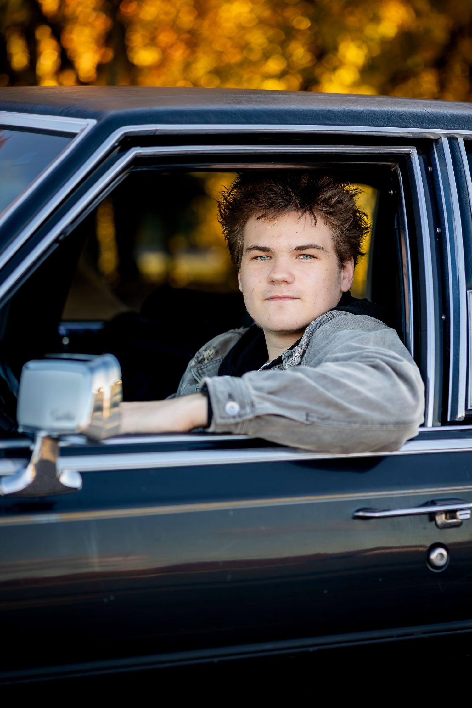 A sequence of photos showing someone sitting in a black car at dusk with warm autumn lighting in the background.