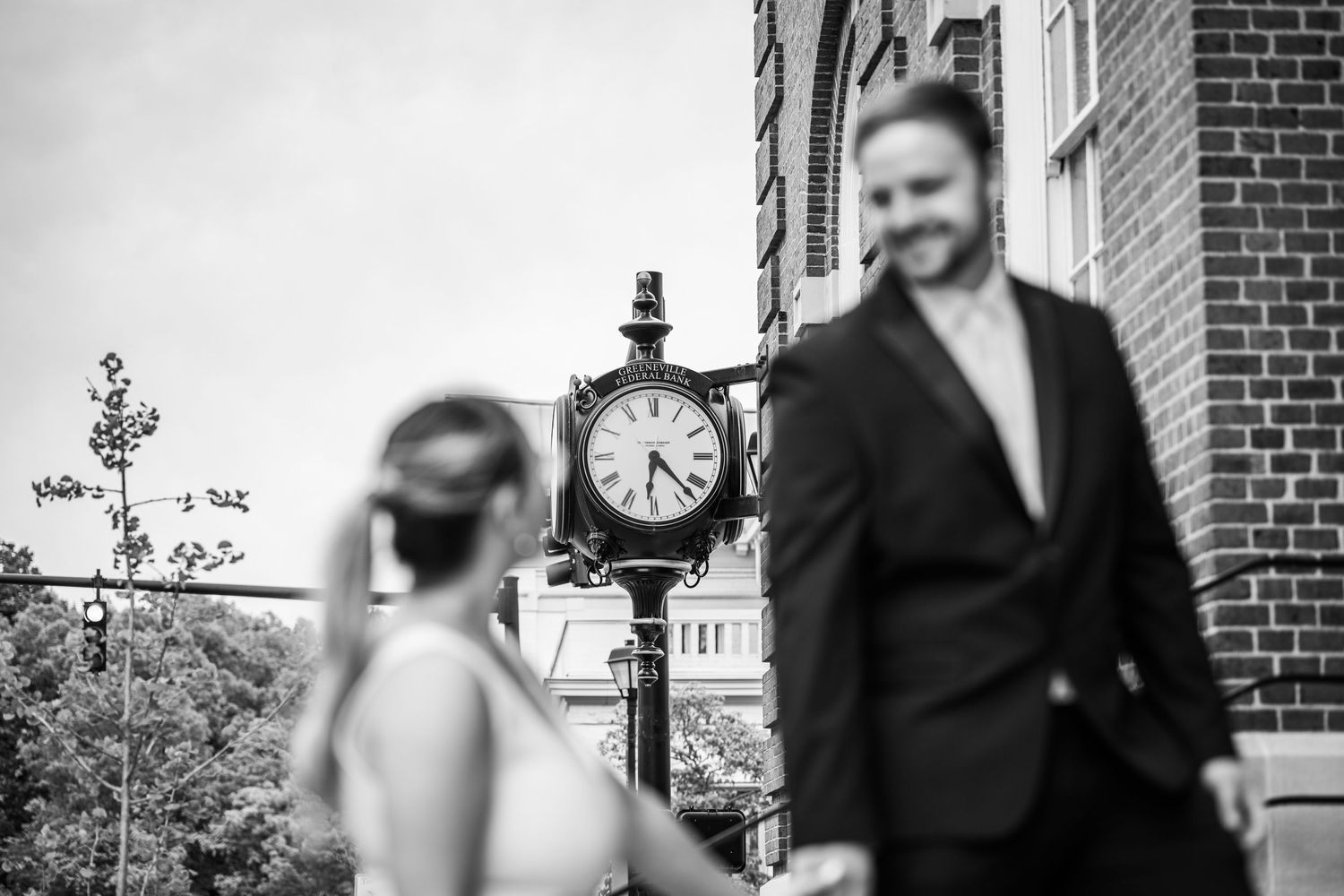 Black and white architectural photo with a vintage clock and brick building details.