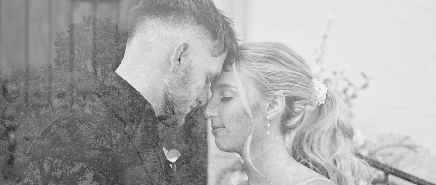 Black and white wedding portrait with soft romantic lighting.