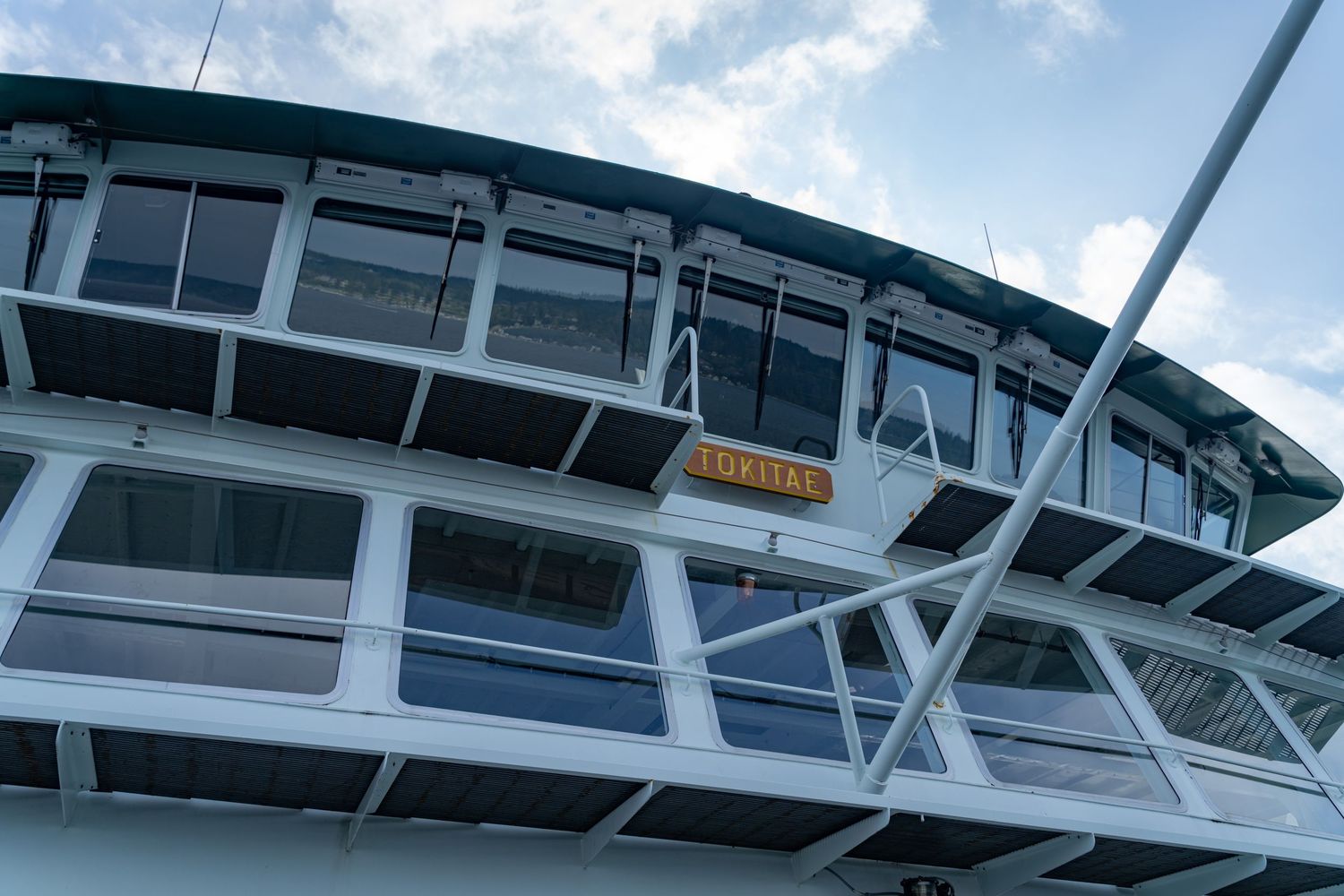 Modern passenger ferry terminal with curved glass architecture and walkways.