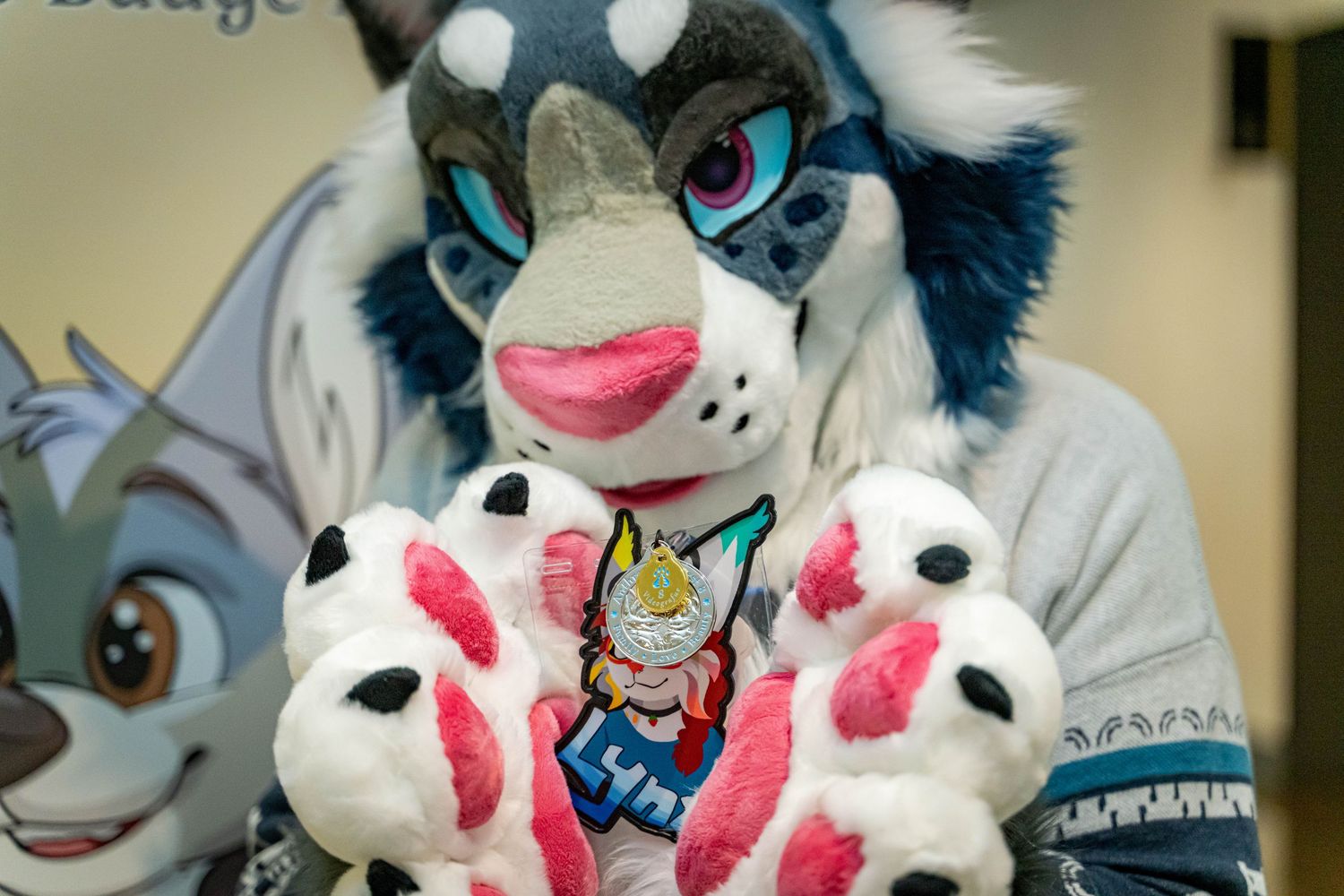 Colorful fursuit mascot characters with blue and white fur posing together in a group photo.