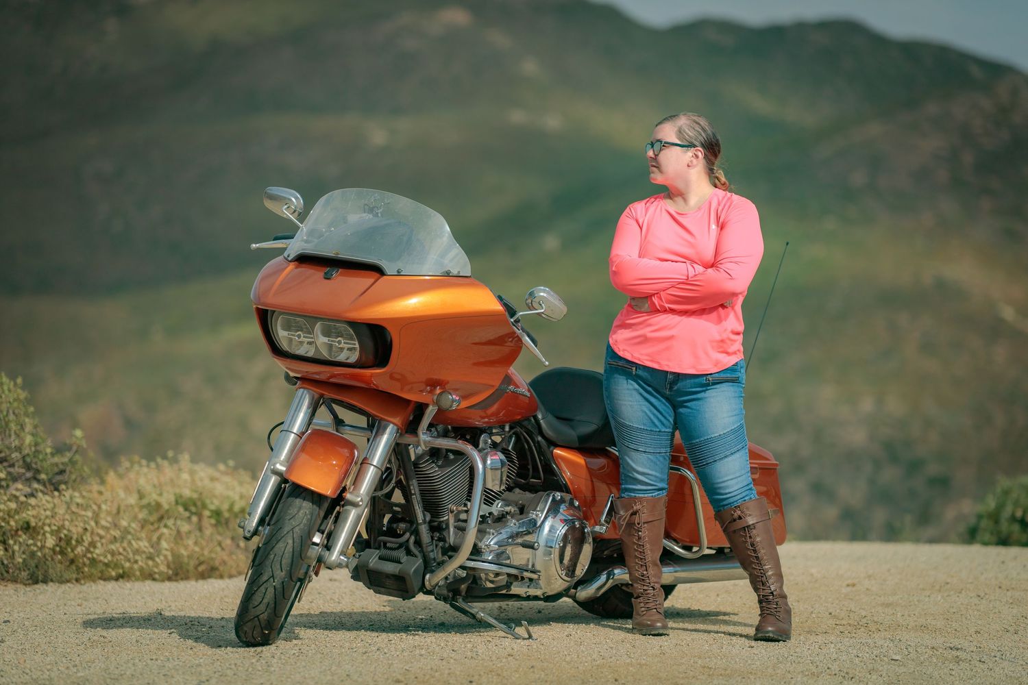 Vintage orange motorcycle shown from multiple angles against a mountainous backdrop at sunset.
