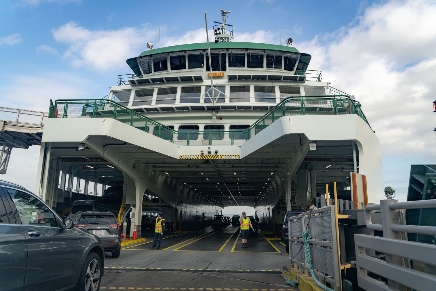 Exterior view of modern ferry terminal building with glass windows and control tower.