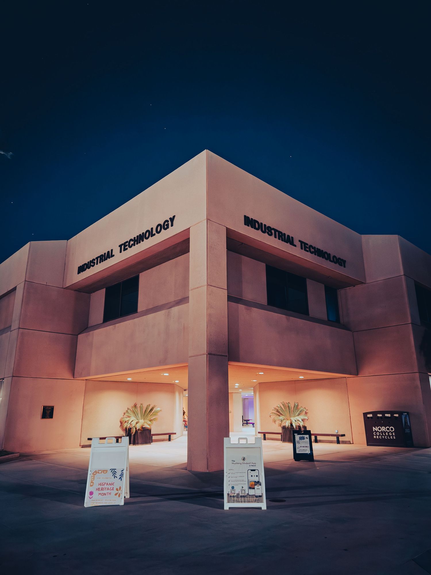 Modern industrial building complex with angular architecture photographed at dusk.