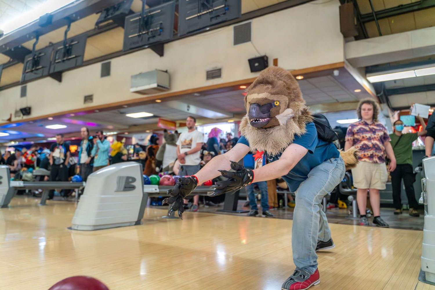 Bowlers in action at a bowling center with multiple lanes visible.