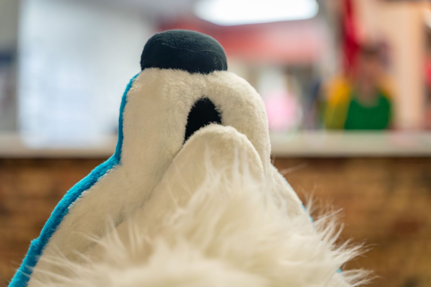Close-up shot of a grey and white fursuit head with blue details.