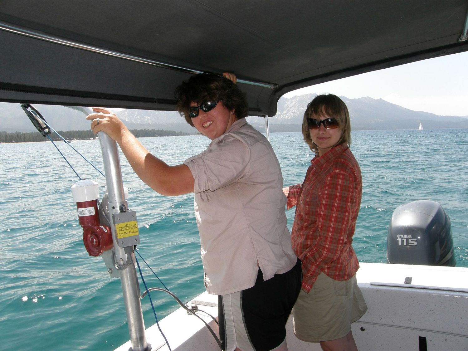 People enjoy a boat trip on turquoise waters under sunny skies.
