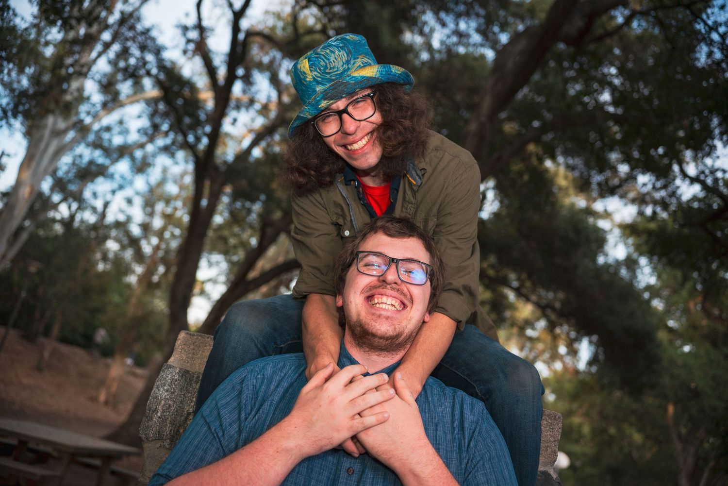 Playful outdoor photo session among tall trees in a natural setting.