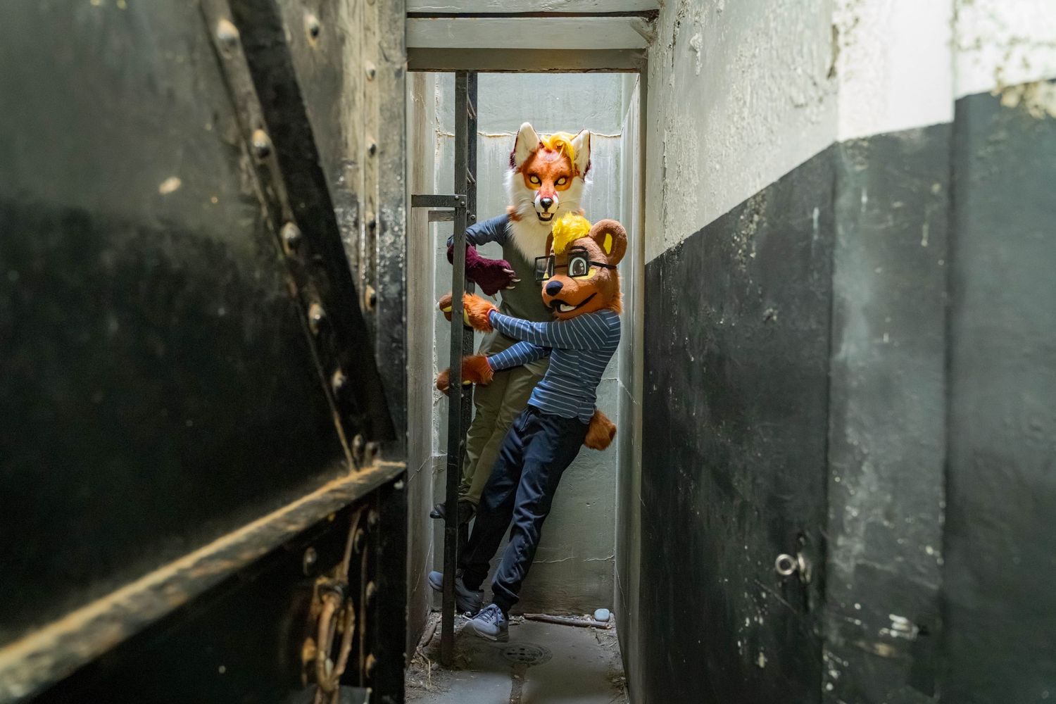 Fursuiter performing parkour moves along concrete corridor walls.