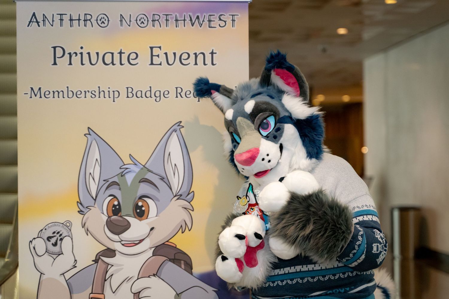 A furry convention sign and plush mascot displayed at Anthro Northwest private event.