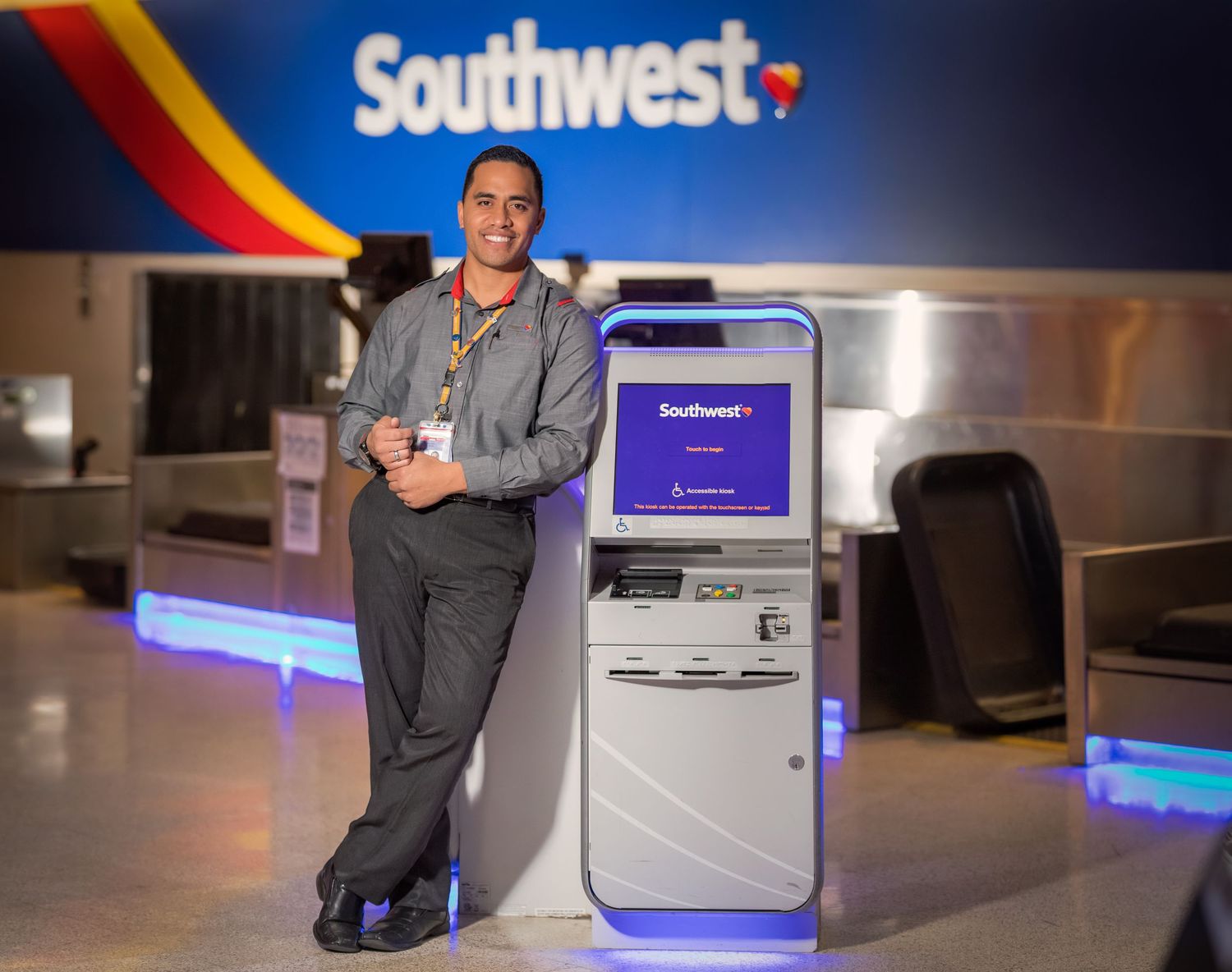 Southwest Airlines check-in kiosks illuminated with blue lighting at night.
