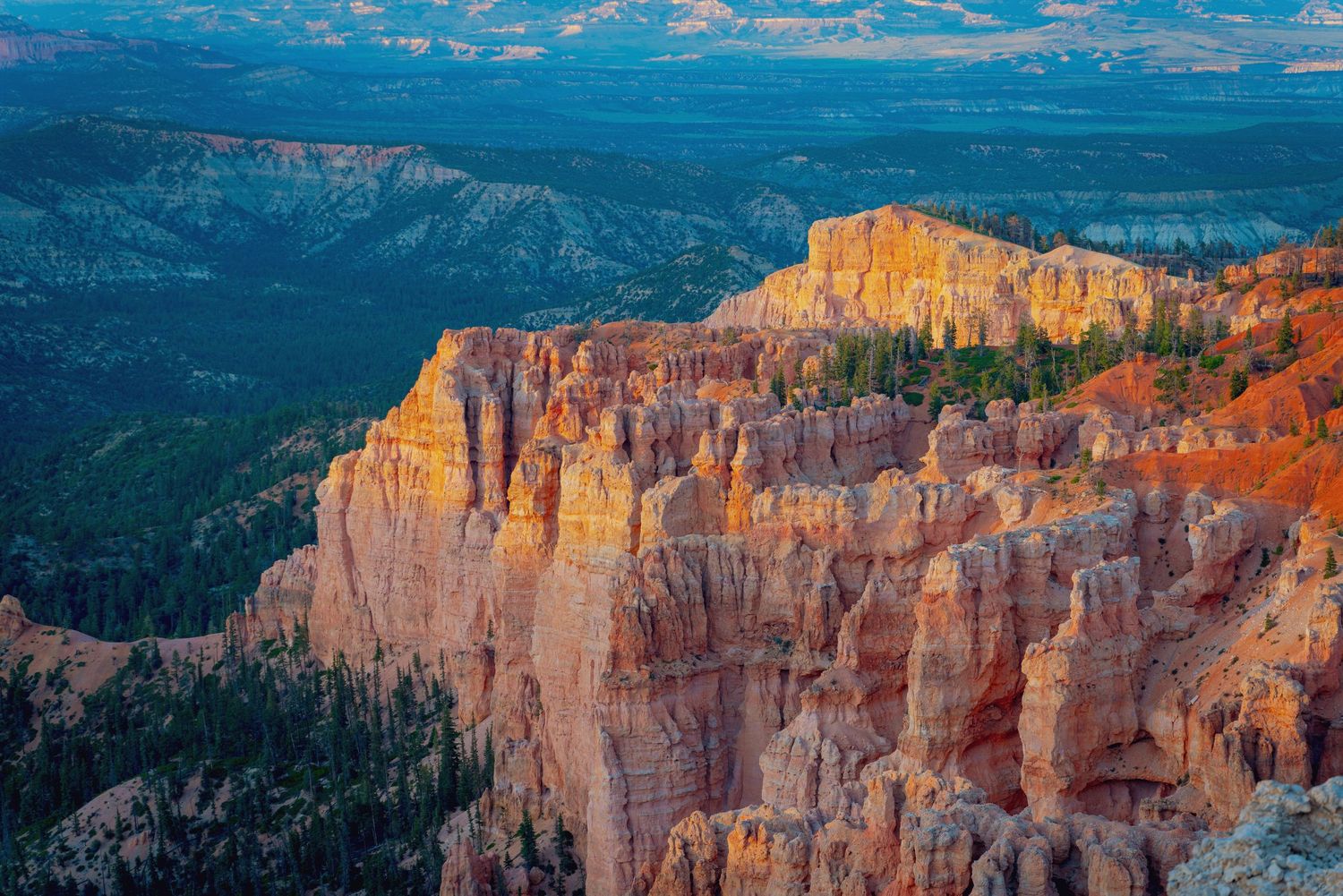 Majestic red rock formations at Bryce Canyon National Park under blue skies.