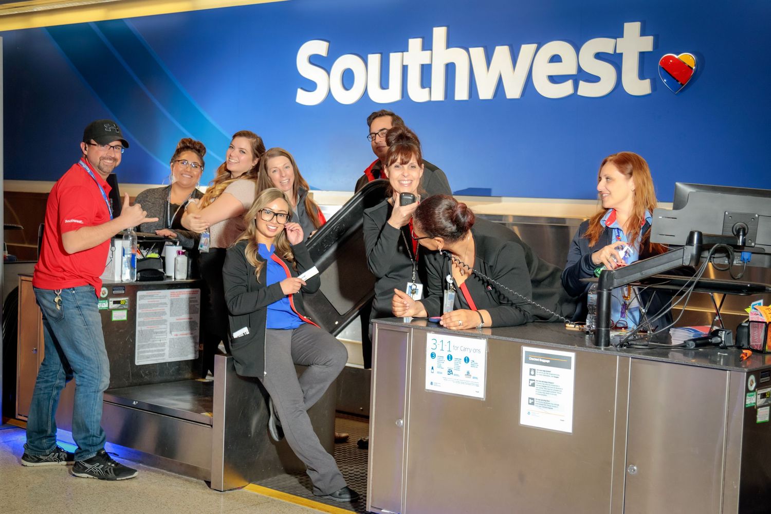 Southwest Airlines check-in counter with staff helping customers.