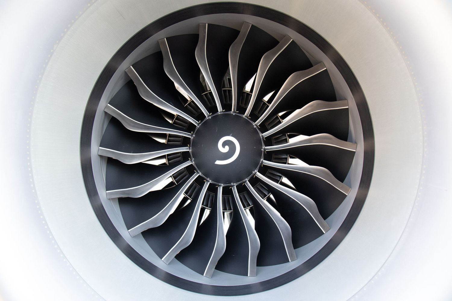 Close-up sequence of jet engine turbine blades showing spiral design pattern.