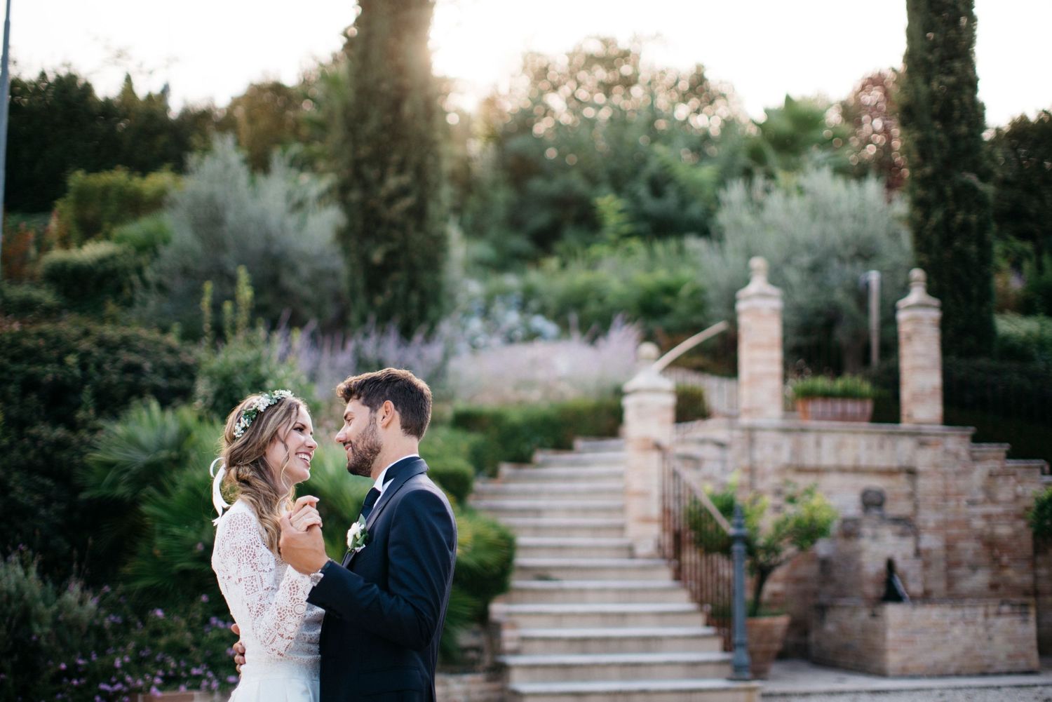 Newlyweds walking through a historic Italian village in Le Marche after their elegant destination wedding ceremony