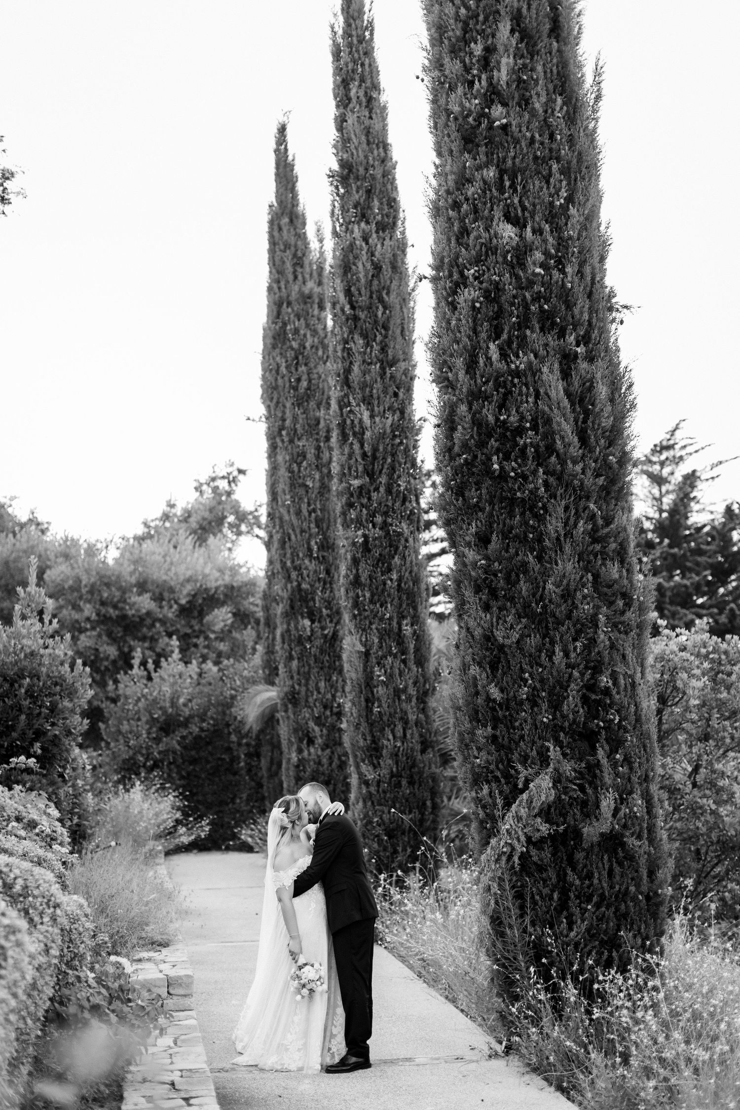 Bride and groom sharing a quiet moment in a romantic courtyard in the countryside of Le Marche, Italy