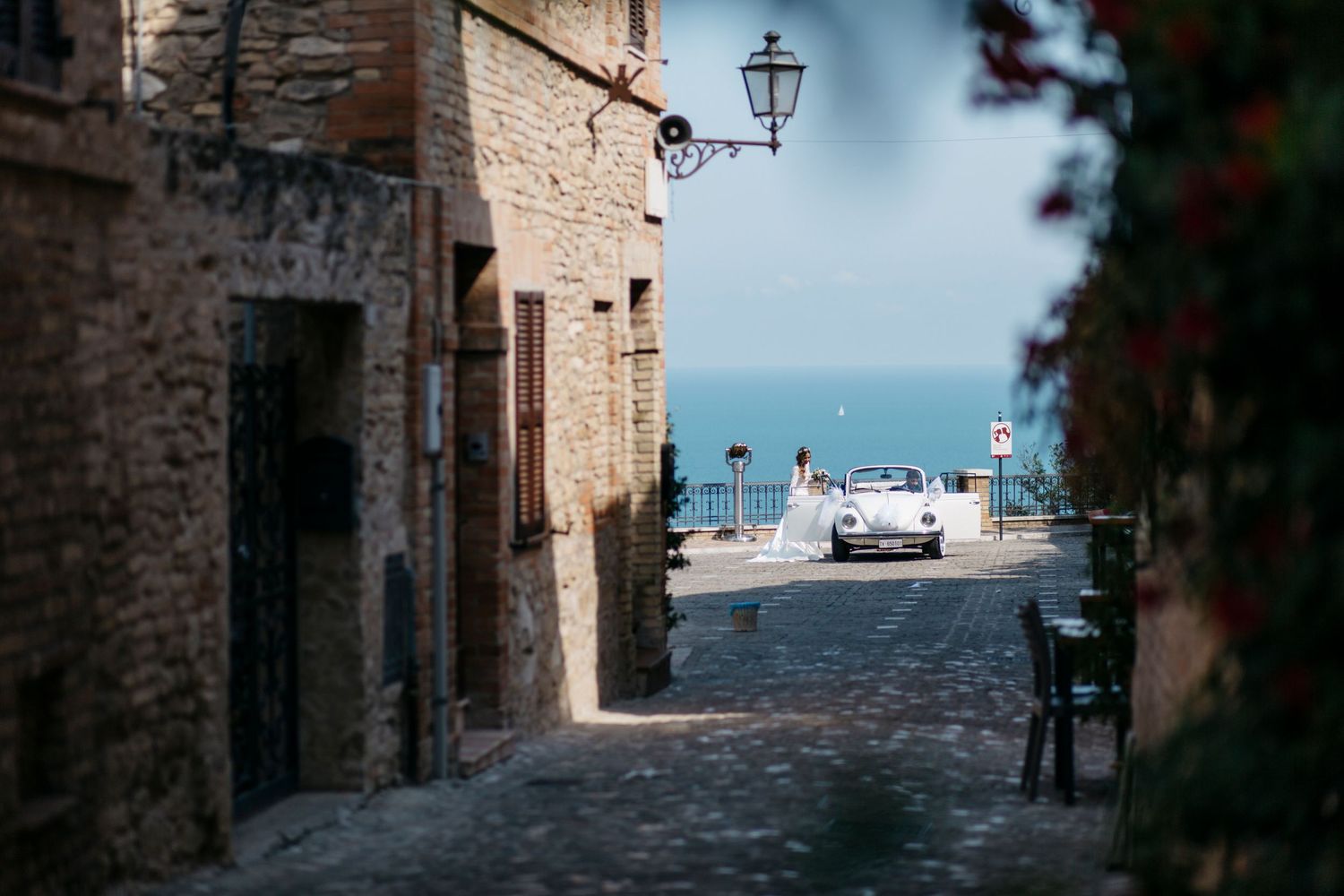 Bride and groom sharing a quiet moment in a romantic courtyard in the countryside of Le Marche, Italy