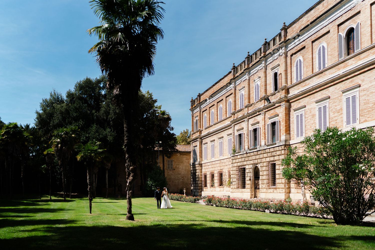 Bride and groom in the gardens of a historic villa in Le Marche, Italy during a destination wedding