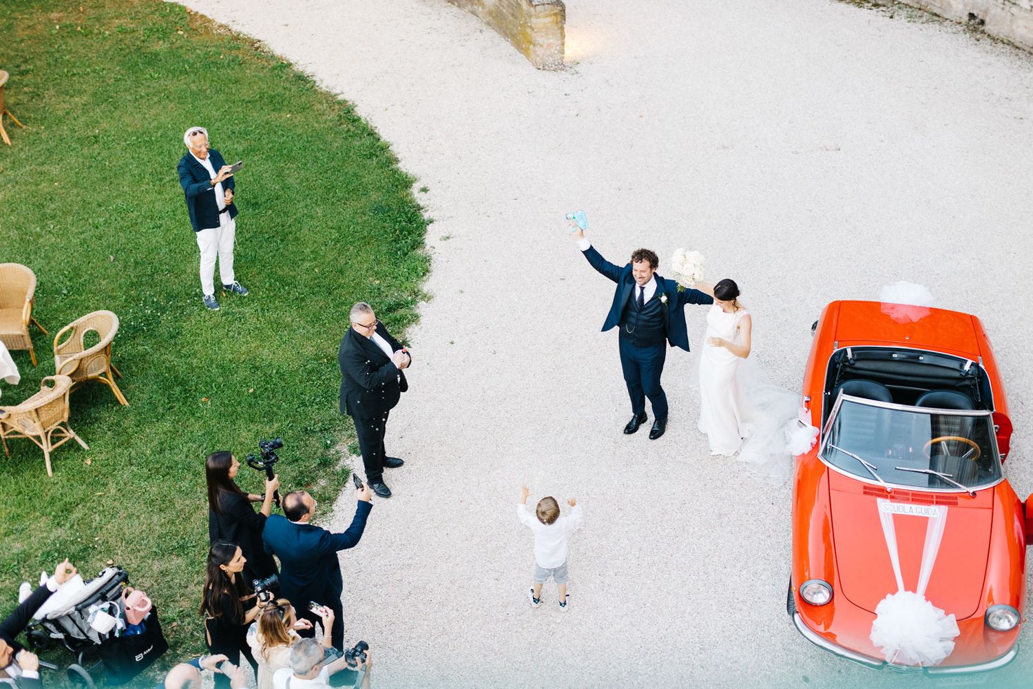 Newlyweds celebrating outside a historic villa in Le Marche during an elegant Italian destination wedding