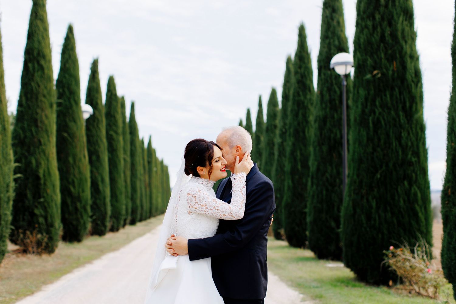 Bride and groom in the gardens of a grand historic villa in Le Marche, Italy during an elegant destination wedding