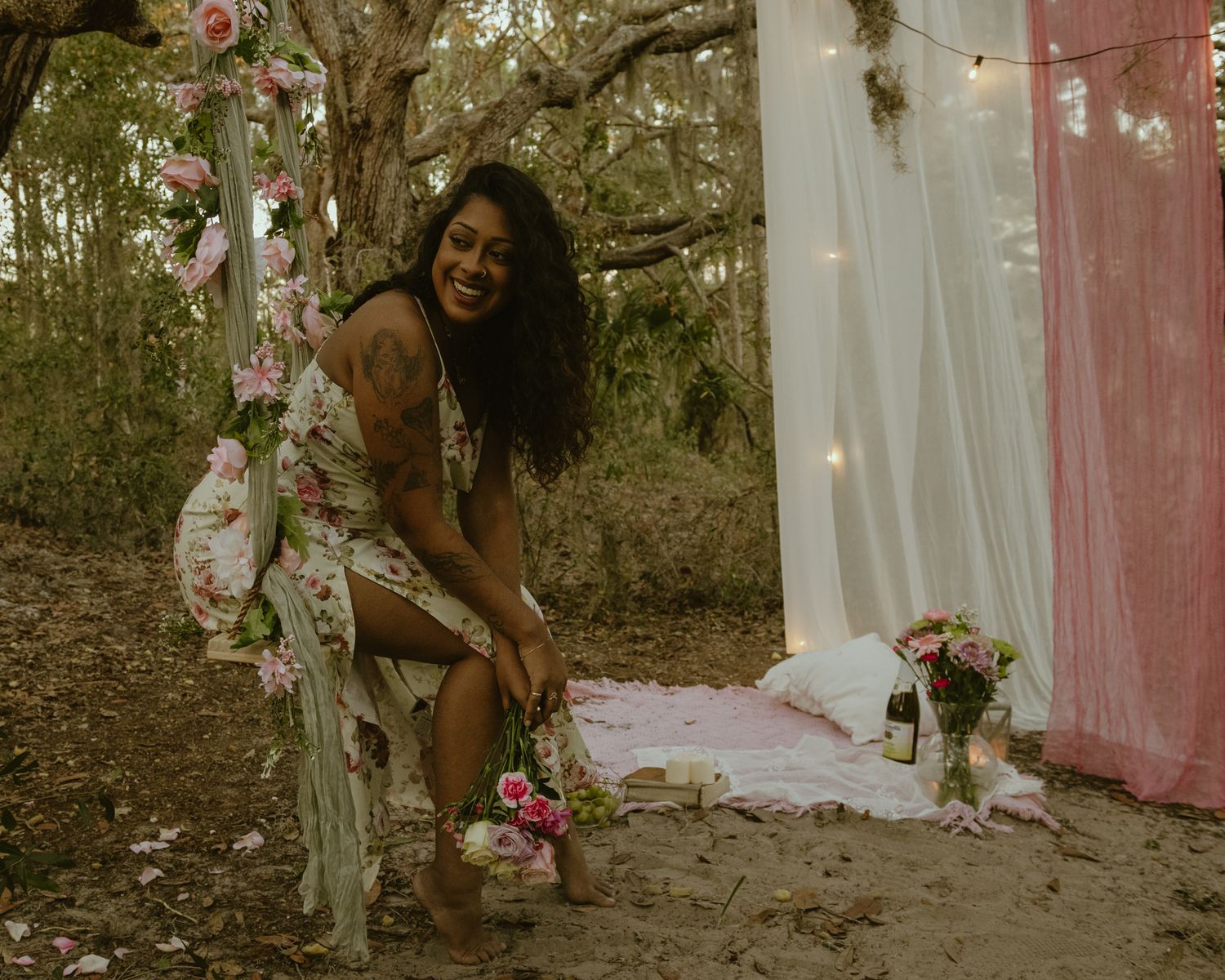 woman sits on a swing hanging from a tree in north tampa. woman wears floral dress