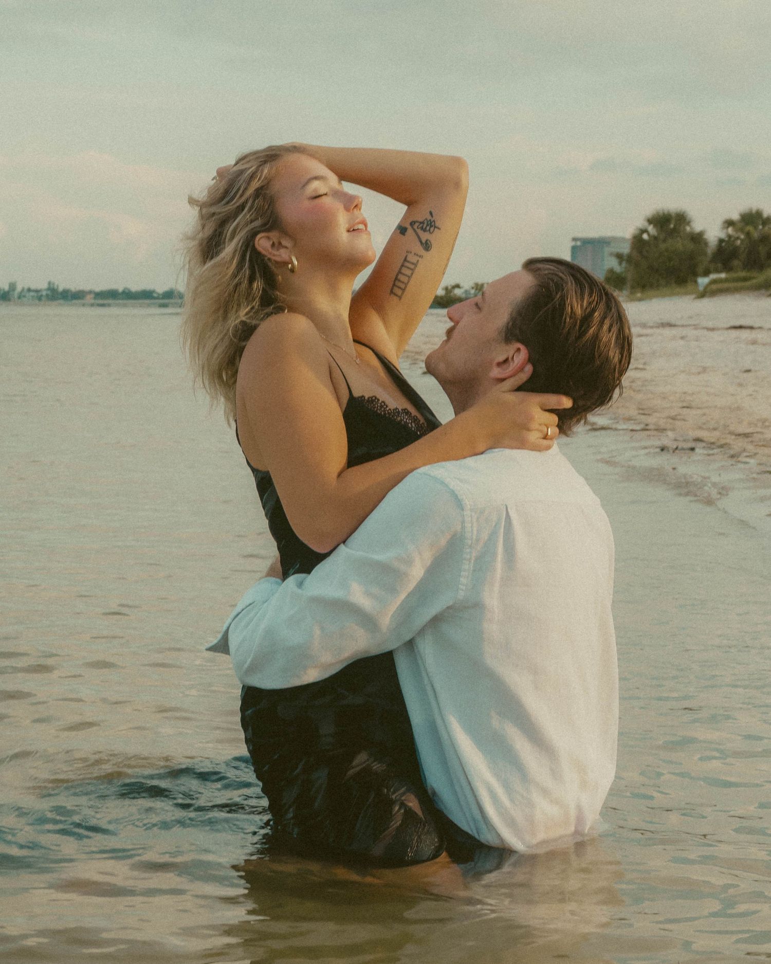 couple poses in the water near tampa international airport