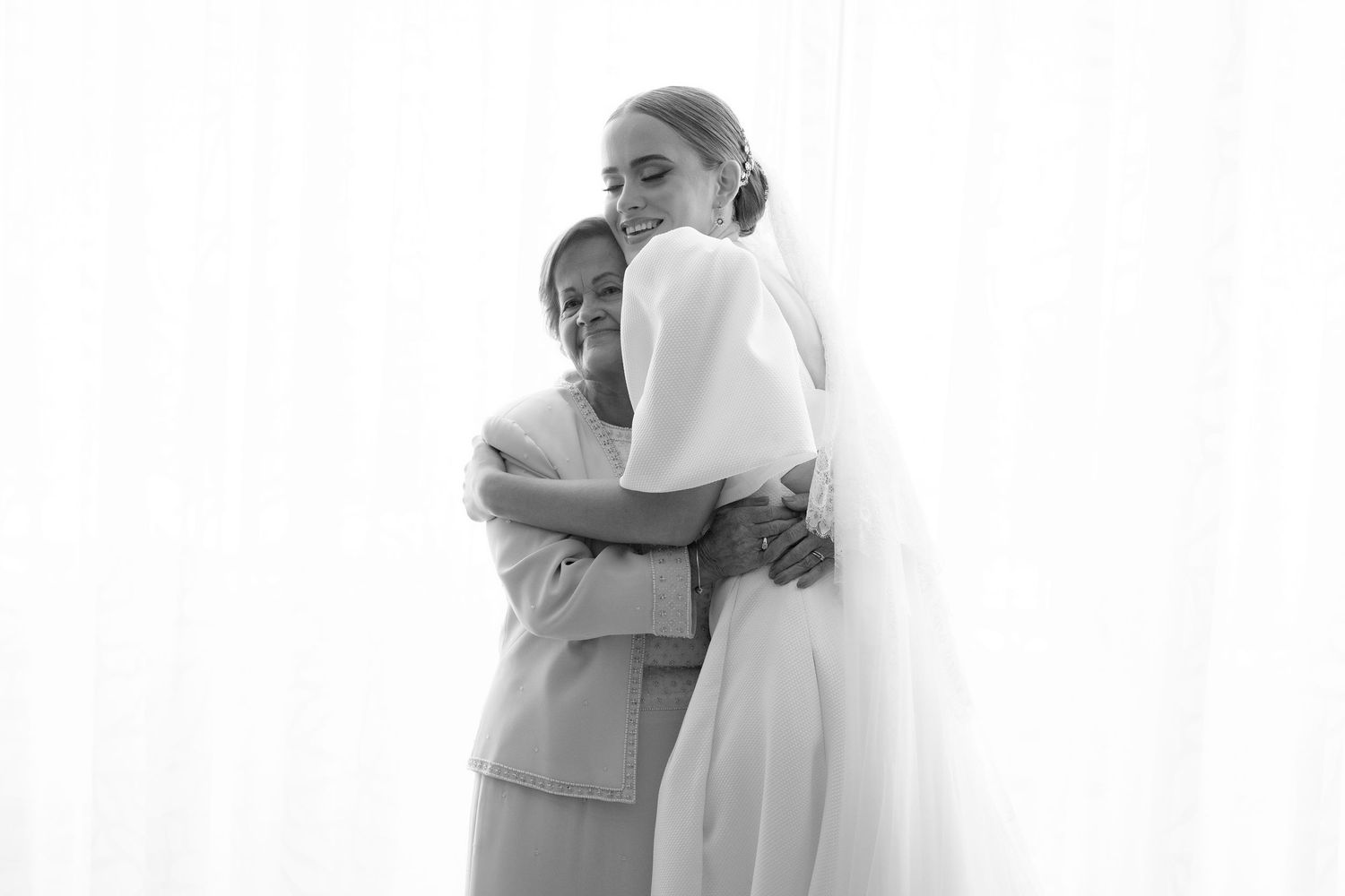 A series of tender embrace moments in monochrome showing emotional connection and comfort between people.