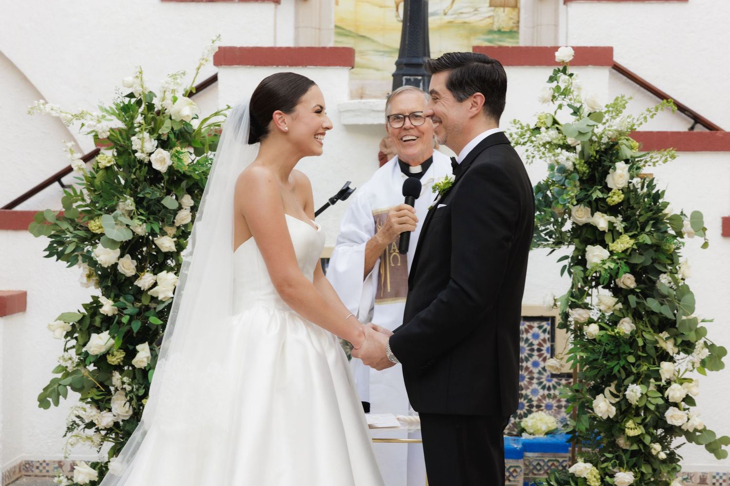 A series of wedding photos showing a couple celebrating under floral arches and sharing intimate moments during their ceremony.