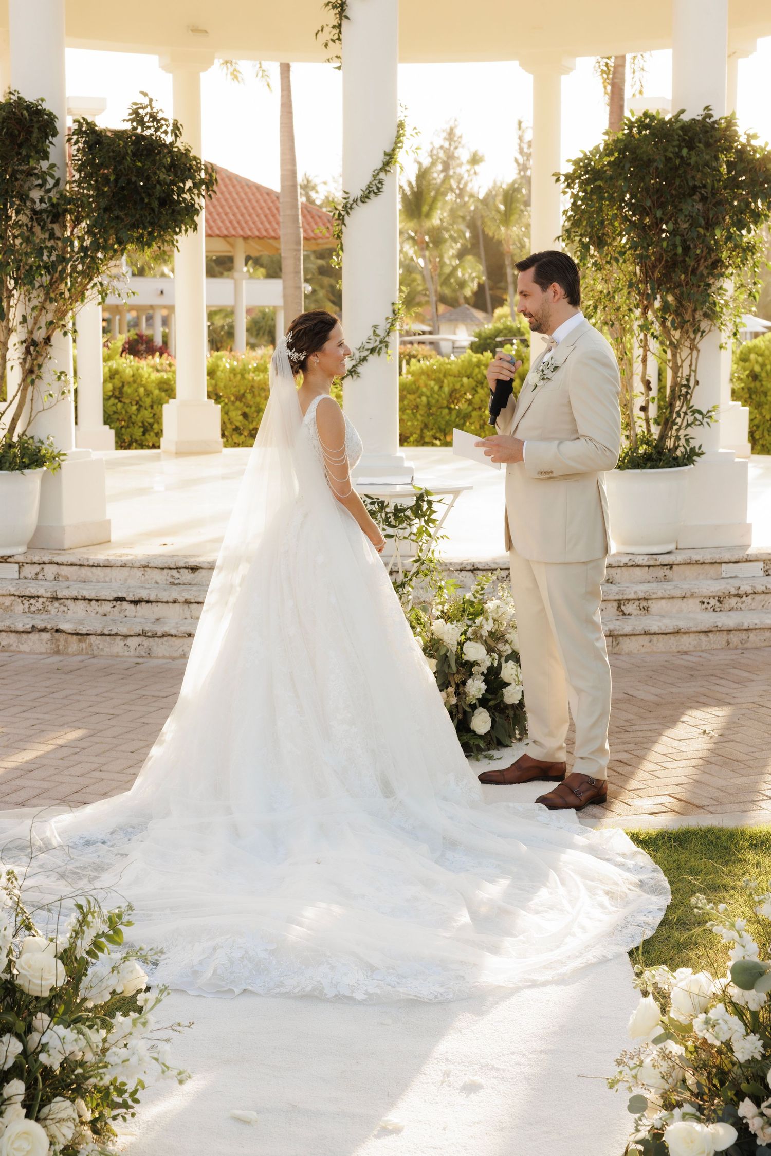 A five-panel sequence shows a romantic first look moment between a couple at an elegant white-columned outdoor venue.