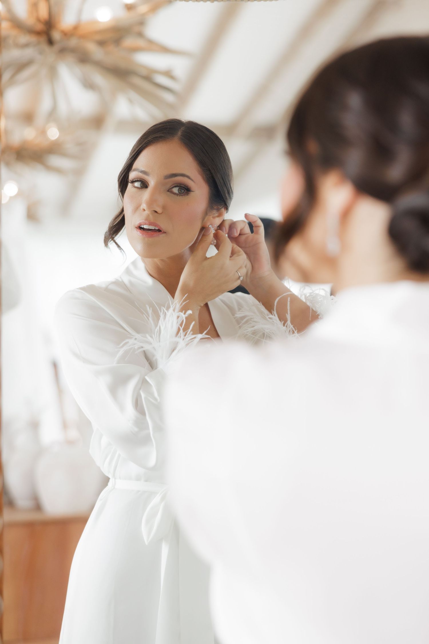 Close-up shots of wedding preparation showing delicate details and white attire.
