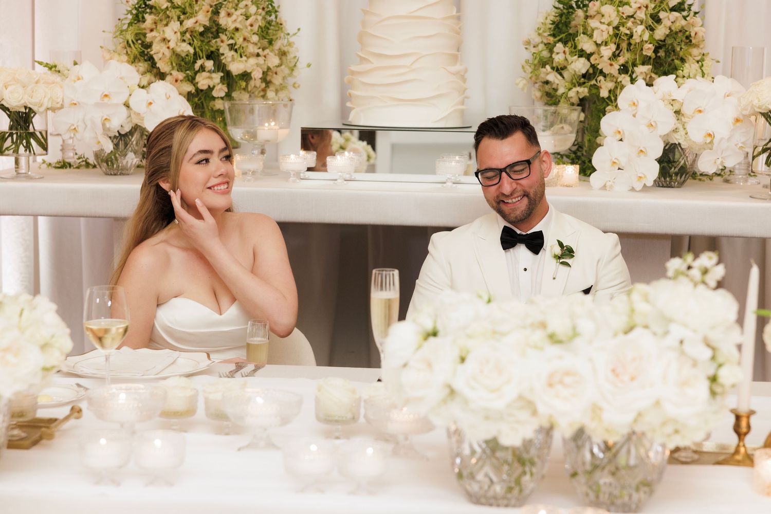 A series of wedding reception photos showing elegant table settings with white floral centerpieces and formal dining decor.