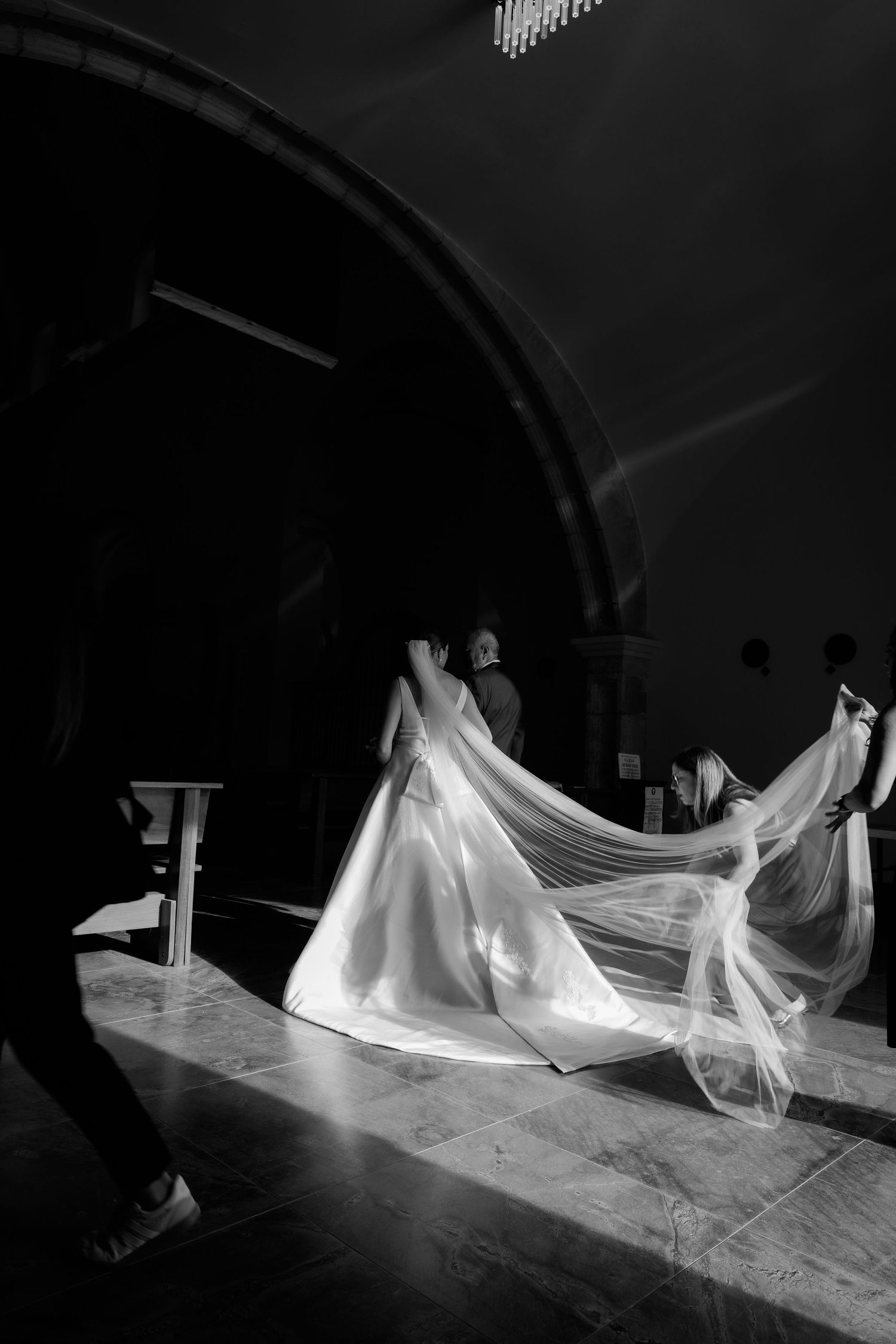 Dramatic black and white shots of flowing wedding dress fabric in motion against dark background.