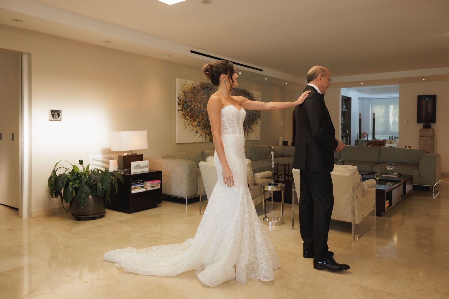 Panoramic view of modern reception area with marble floors and contemporary furniture.