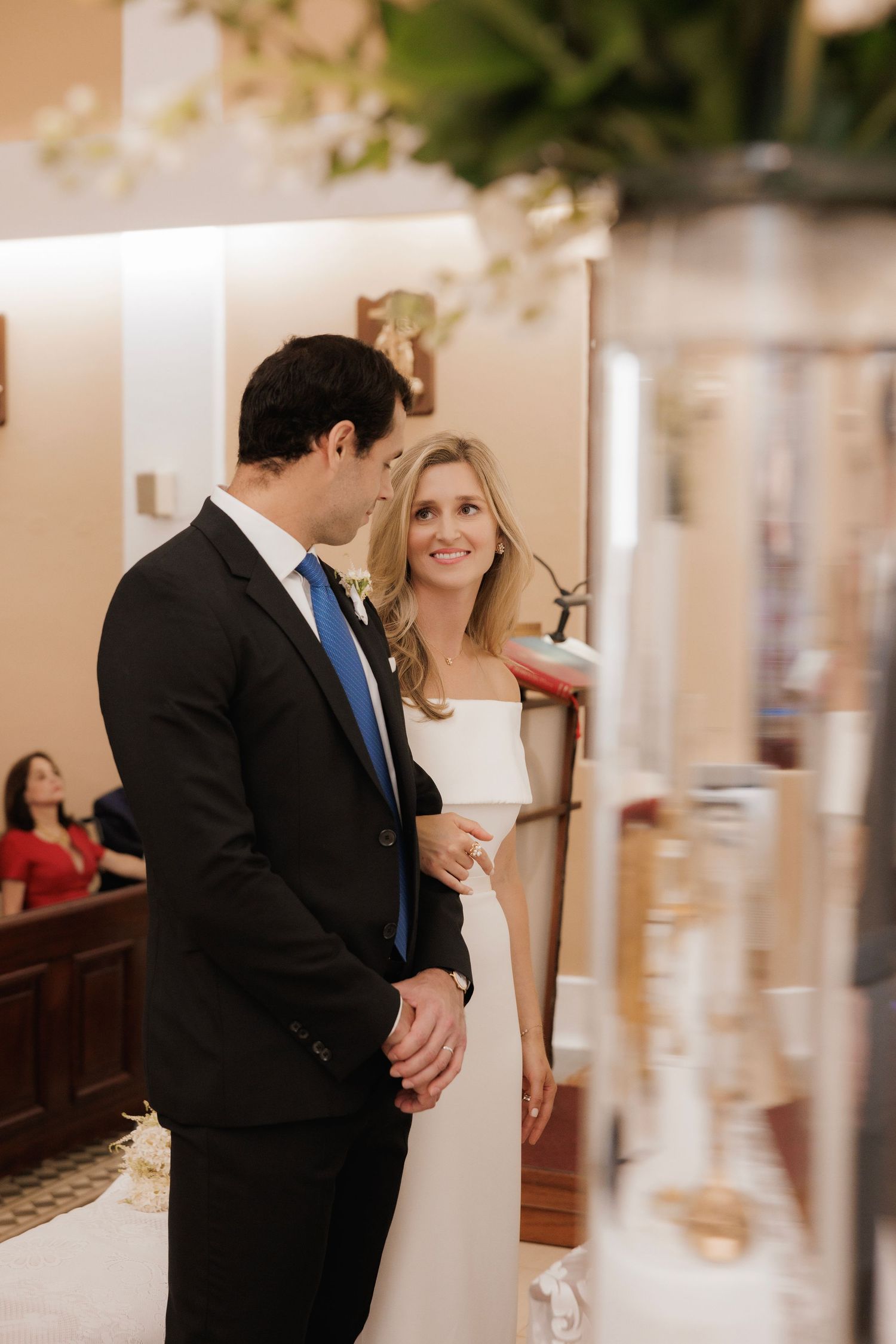 A romantic wedding photo series showing intimate moments between a couple in formal attire in an indoor venue.