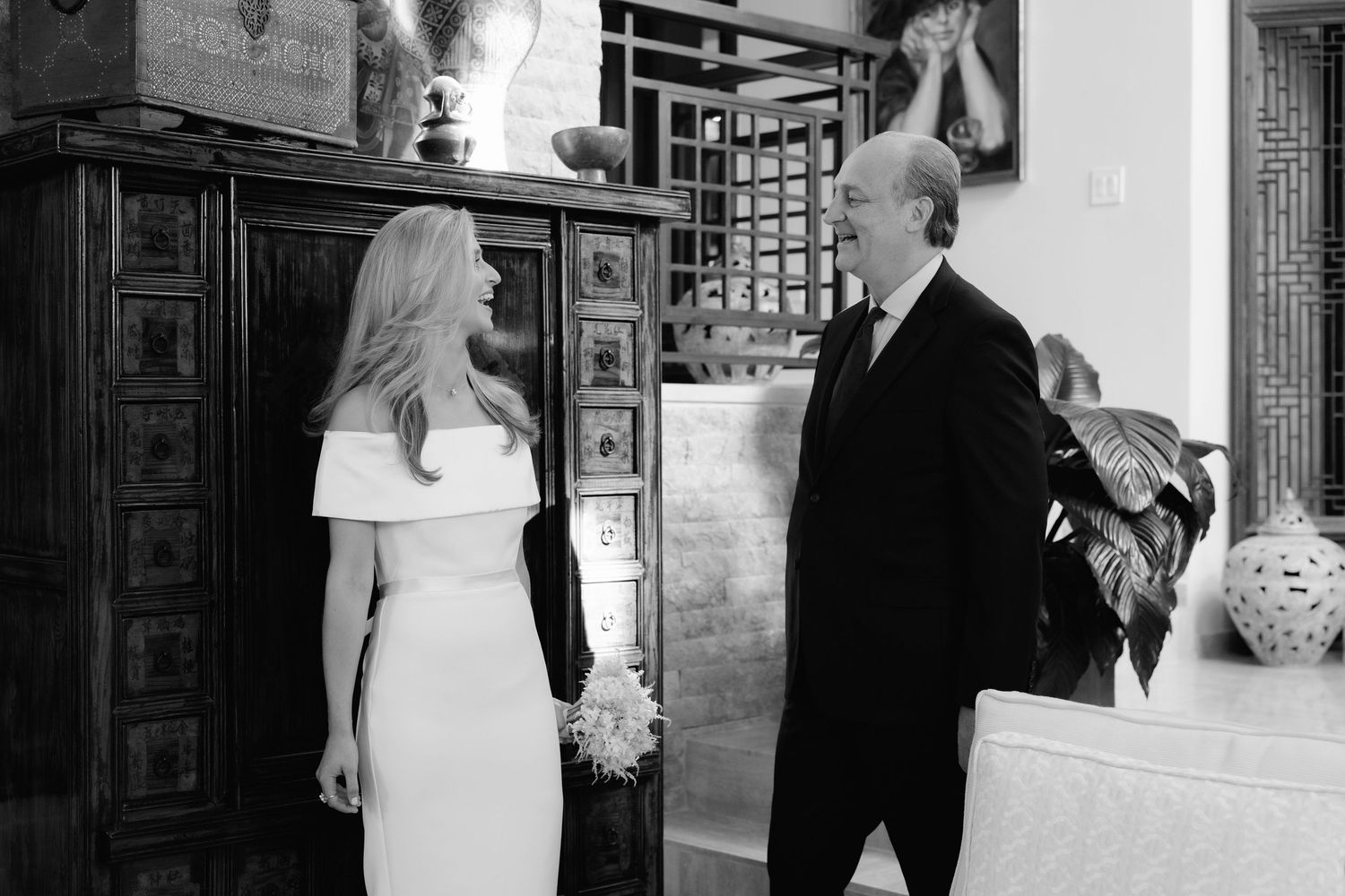A series of candid black and white photos set up horizontally showing a couple's wedding moments in a traditional venue.