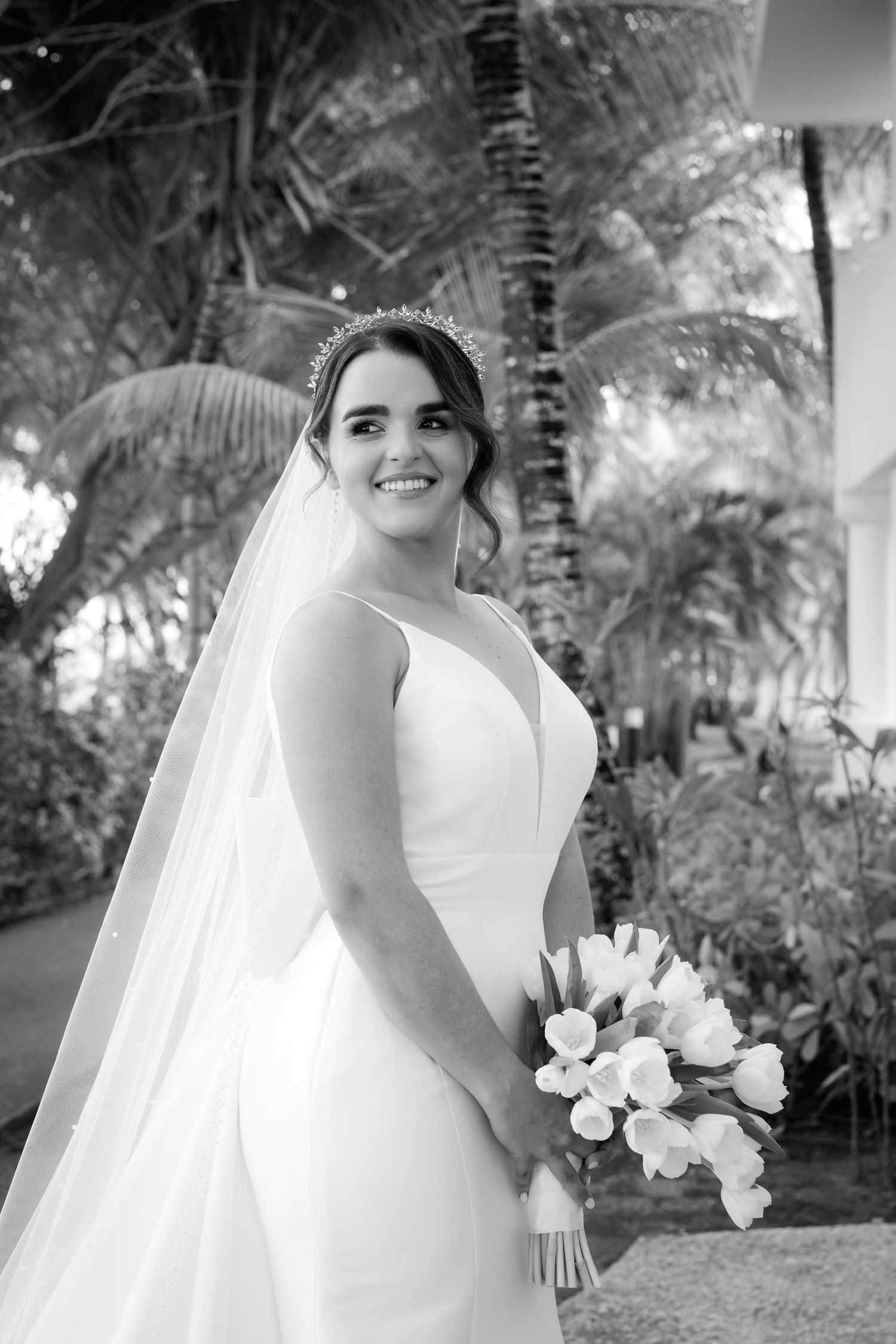 A black and white wedding photo sequence showing a bride in a white dress and veil holding a bouquet in an outdoor garden setting.