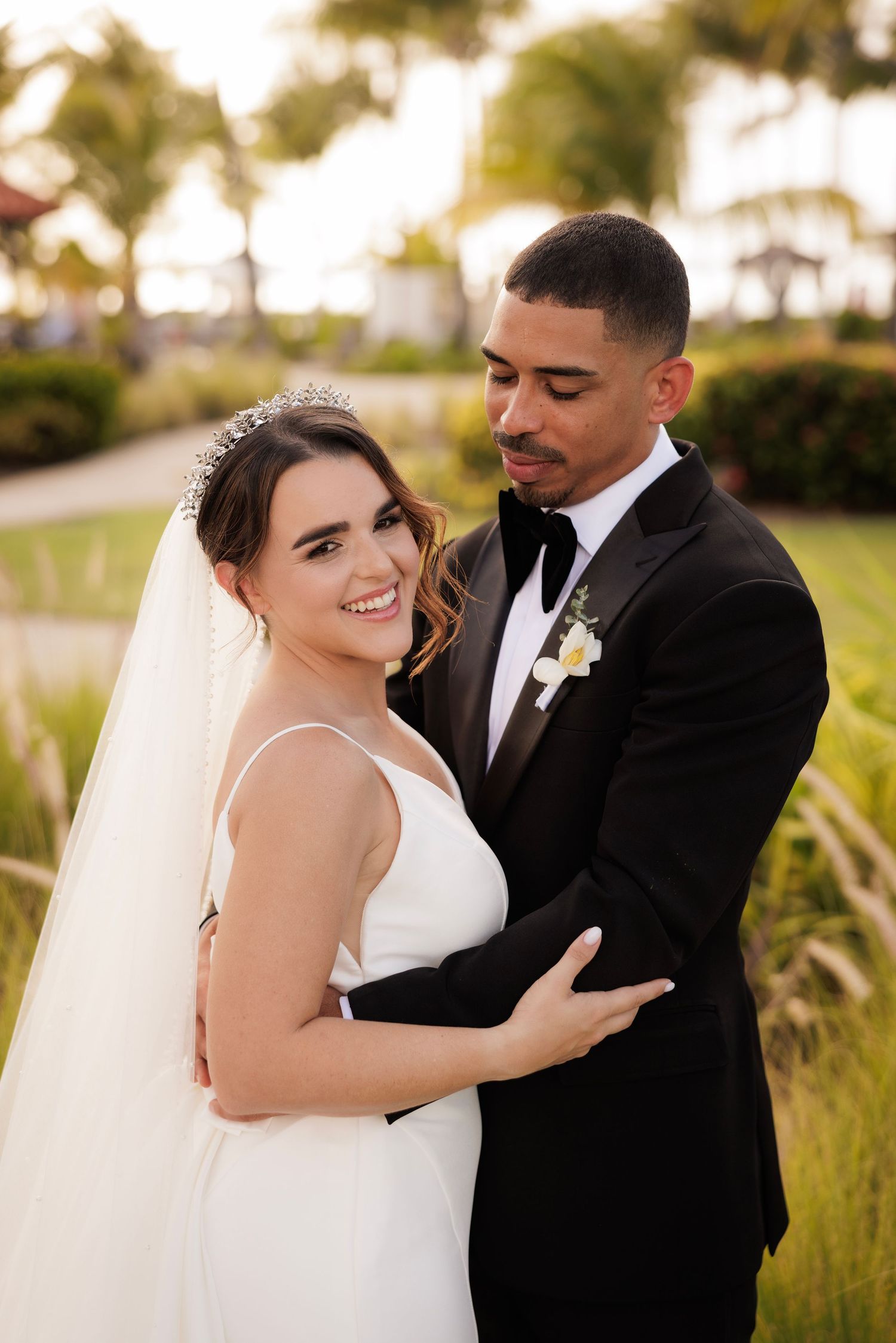 A tender wedding moment captured in a series of five photos showing a couple embracing outdoors with golden sunlight.