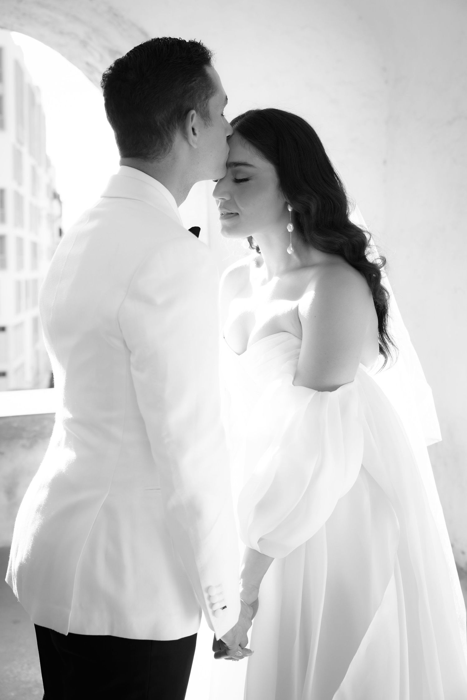 Intimate black and white wedding photos showing tender moments between the couple.