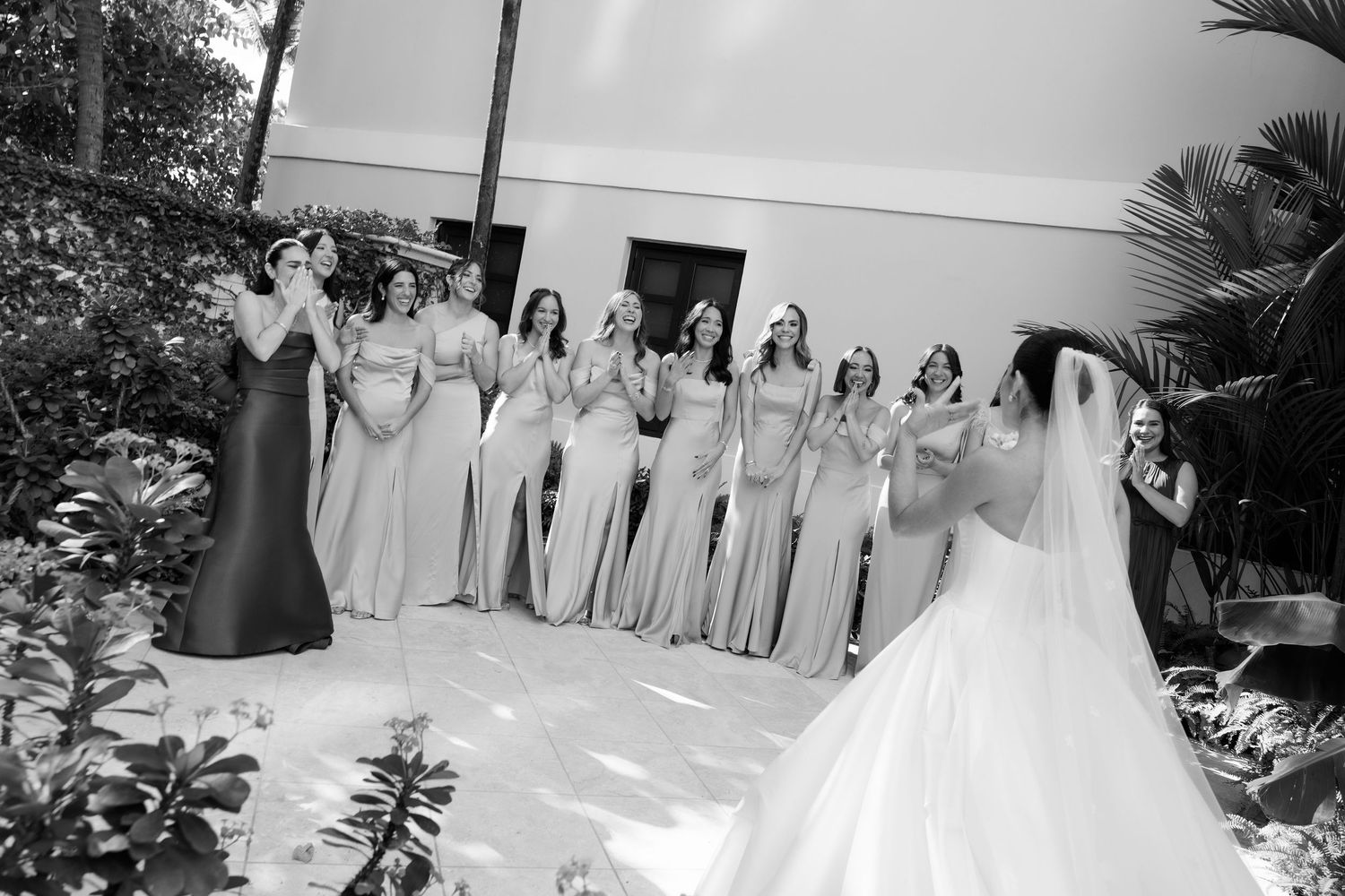 A black and white wedding party photo collage shows a celebration with bridesmaids in light colored dresses outdoors.