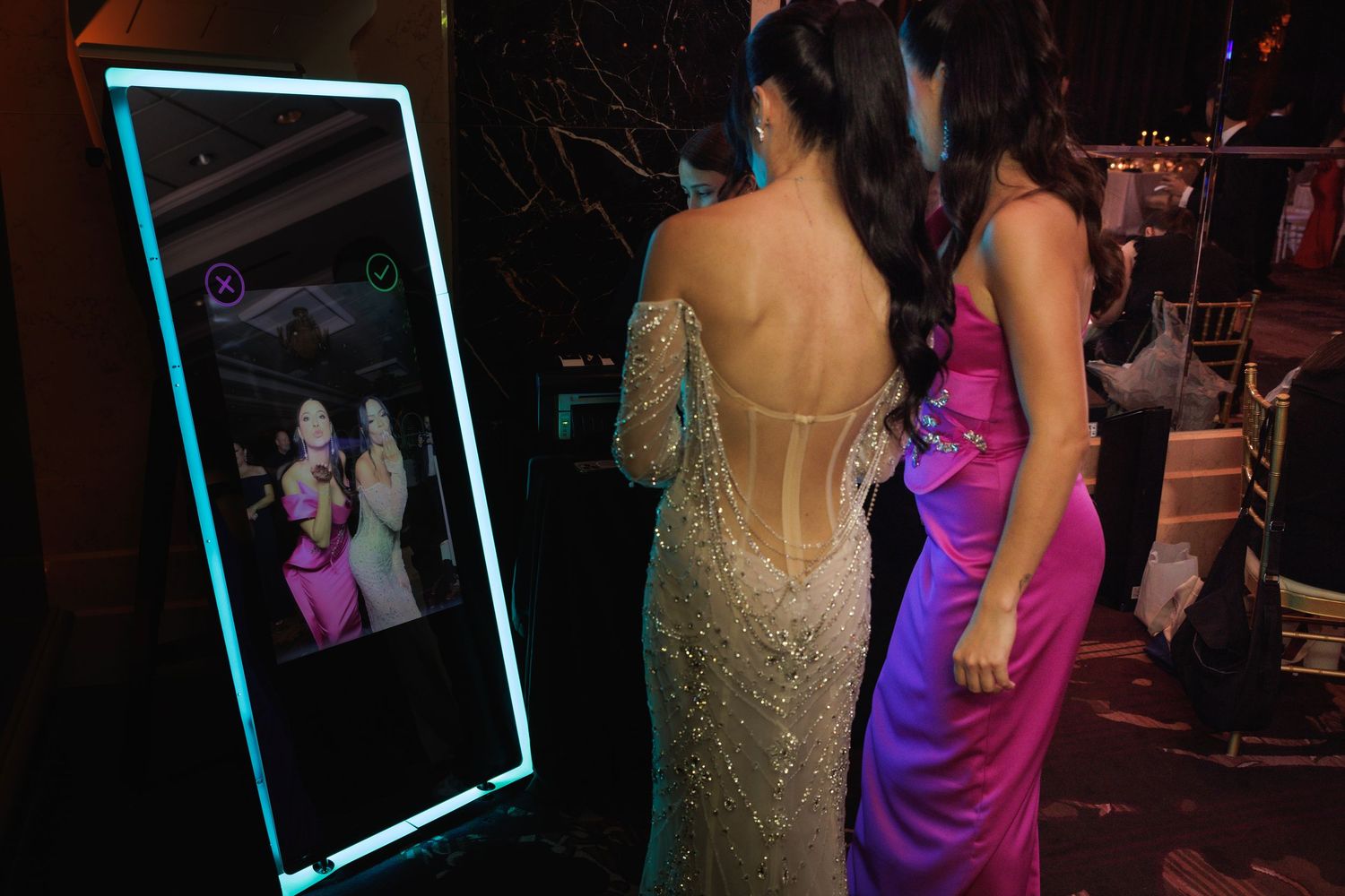 A wedding reception dance floor filled with elegantly dressed guests in evening wear enjoying the celebration.